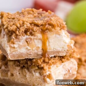 Caramel Apple Cheesecake Bars sliced and stacked on top of one another on table