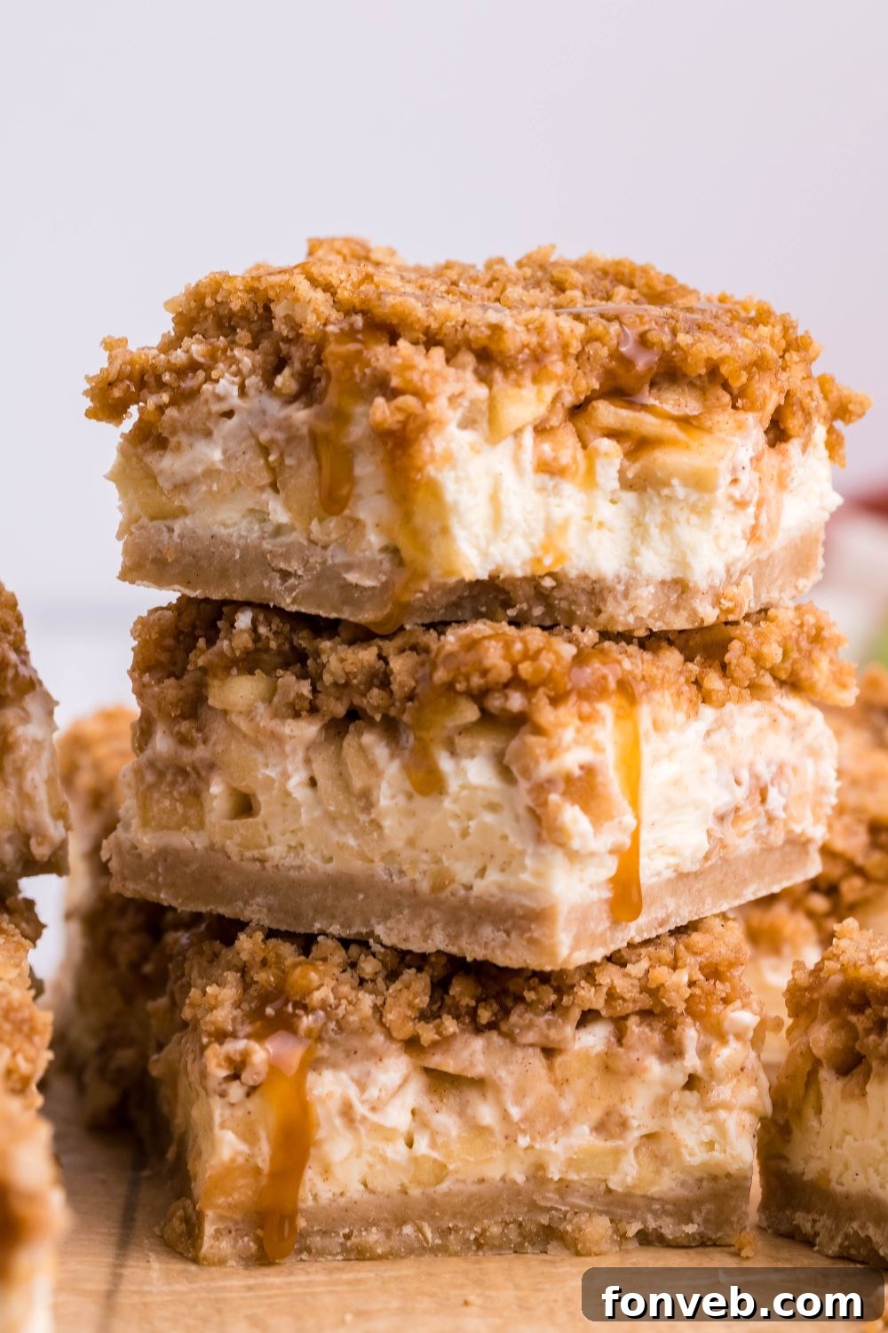 Caramel Apple Cheesecake Bars stacked on top of one another 
