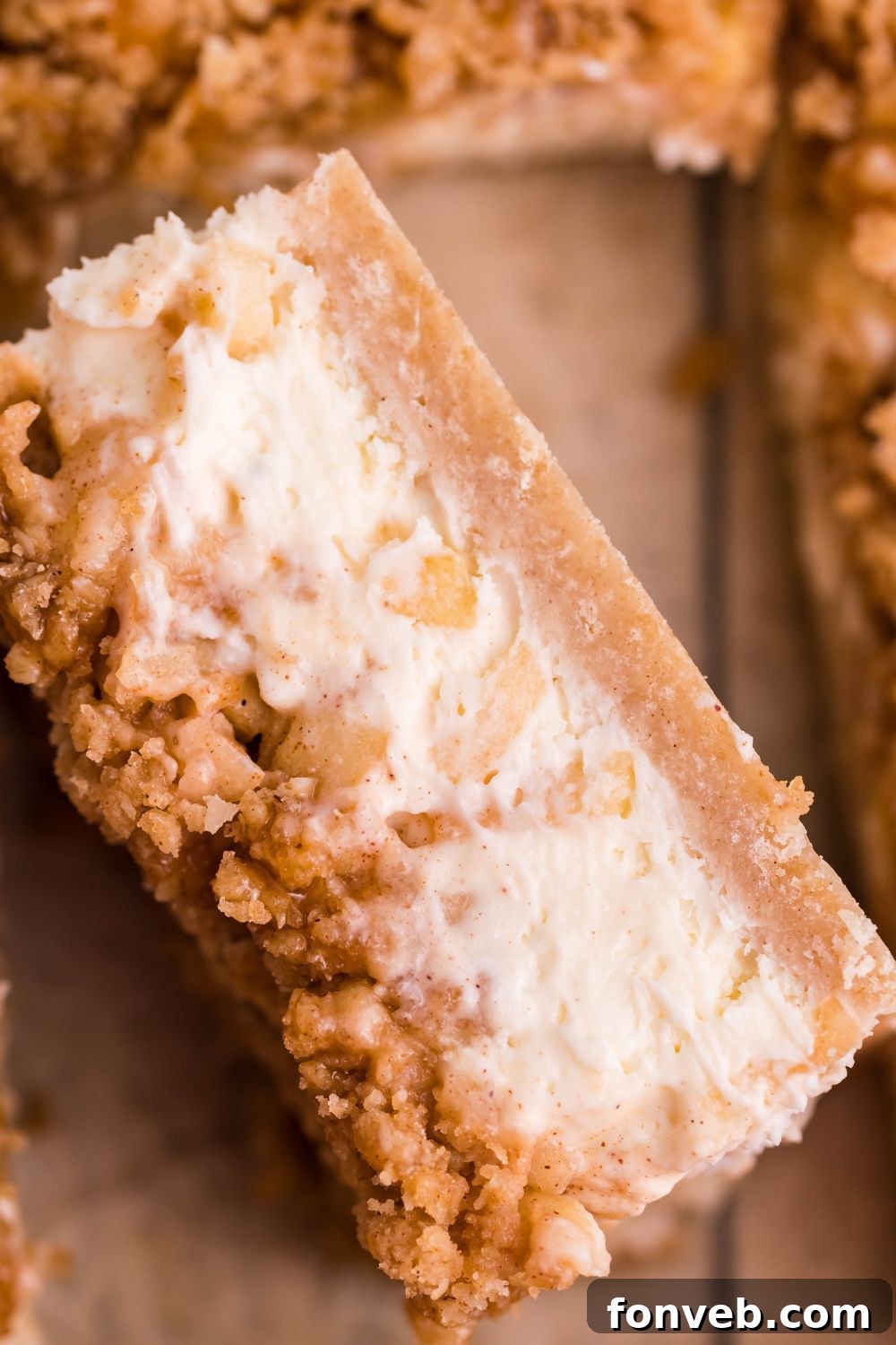 Caramel Apple Cheesecake Bar on its side showing the layers 