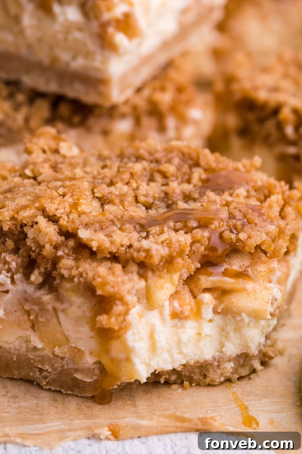 Caramel Apple Cheesecake Bar on table with a bite taken out of it 