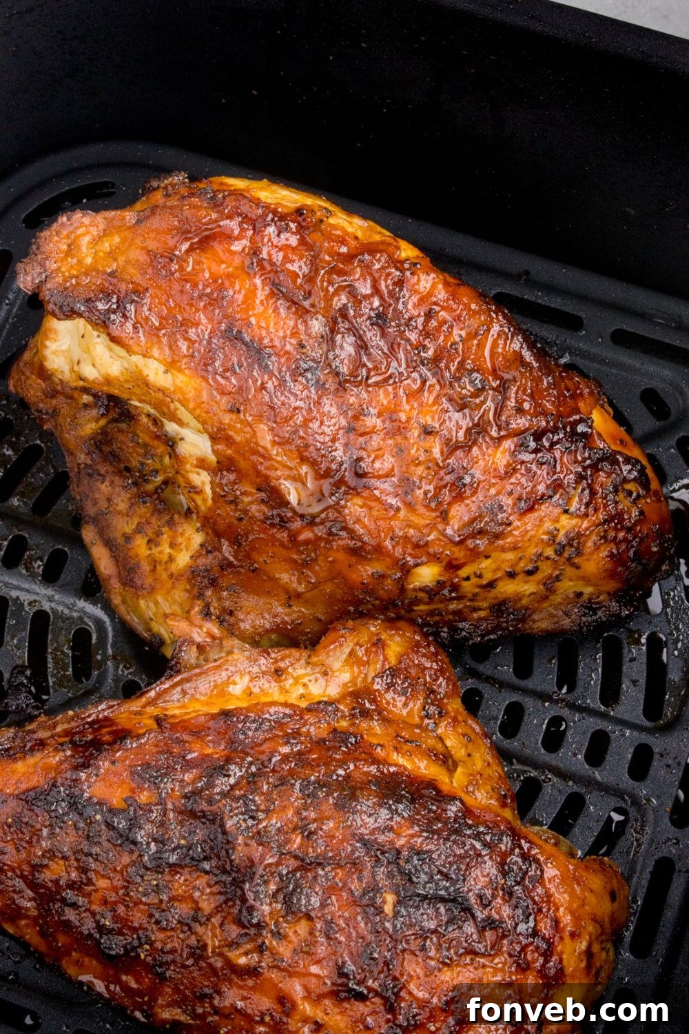 Air Fryer Chicken Breast basket with cooked chicken inside 