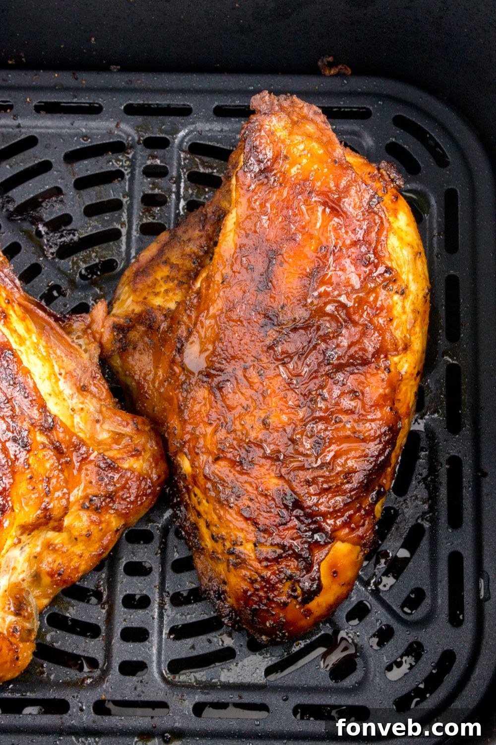 Air Fryer Chicken Breast cooked and in an air fryer basket 