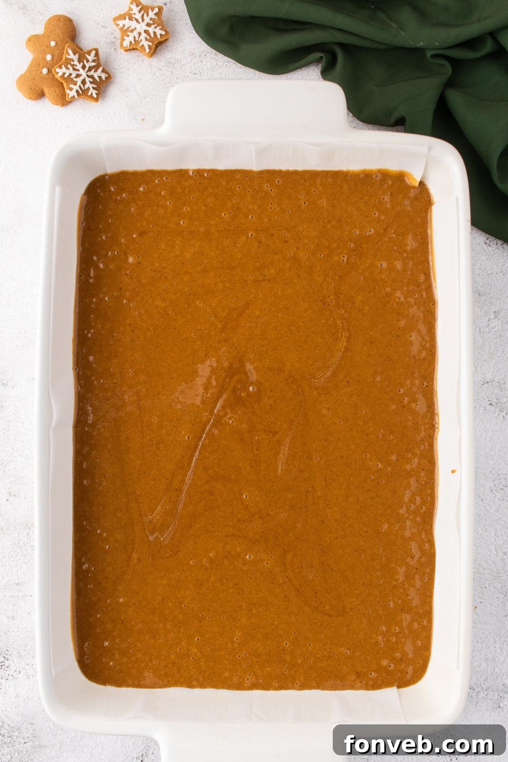 raw gingerbread cake batter in a pan