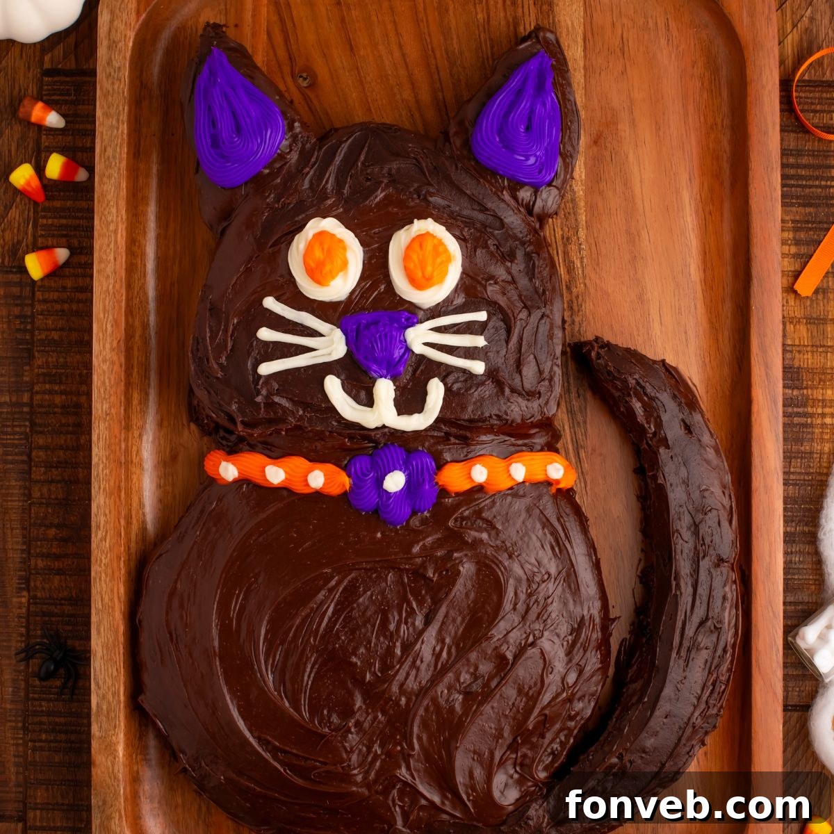Purrfectly Simple 4-Ingredient Black Cat Halloween Cake 2 Halloween Black Cat Cut Out Cake on serving tray sitting on table with festive Halloween decorations