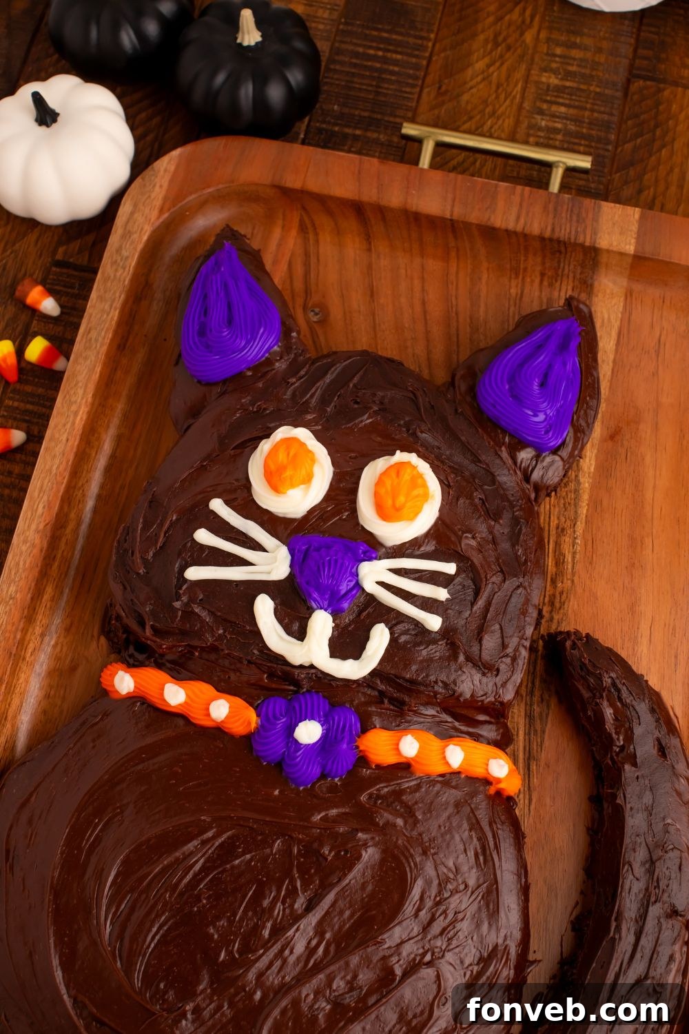 Purrfectly Simple 4-Ingredient Black Cat Halloween Cake 12 Easy Halloween Black Cat Cut Out Cake sitting on a wooden tray on table, ready to be enjoyed as a festive Halloween treat