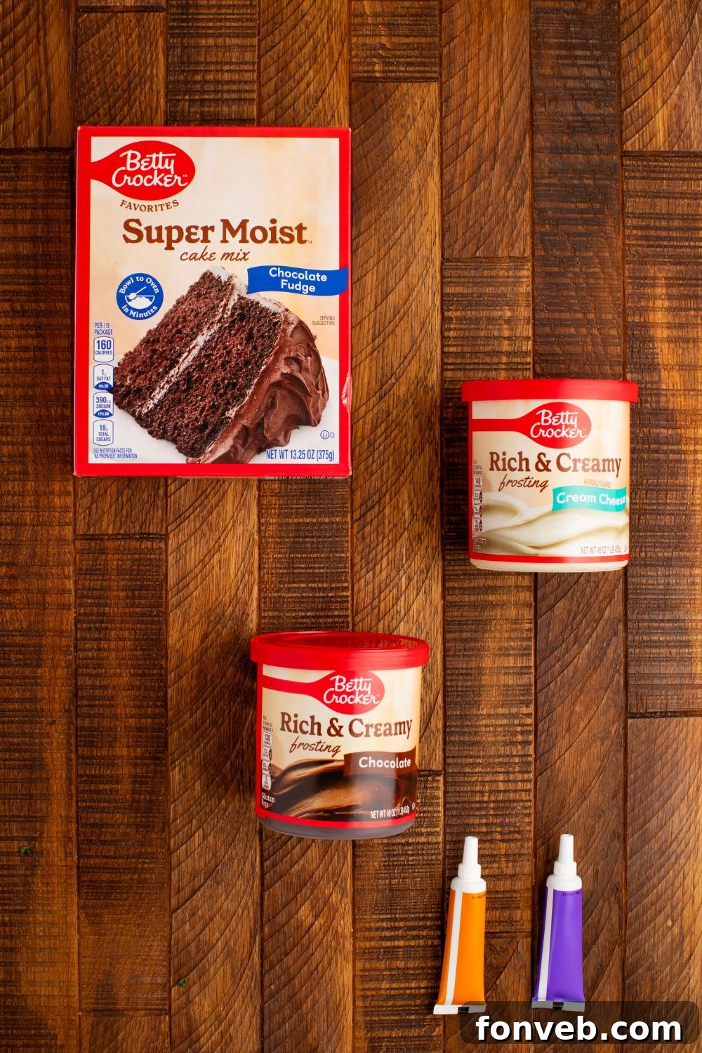 Purrfectly Simple 4-Ingredient Black Cat Halloween Cake 4 Ingredients for making Easy Halloween Black Cat Cut Out Cake in containers sitting on the wooden table, ready for baking