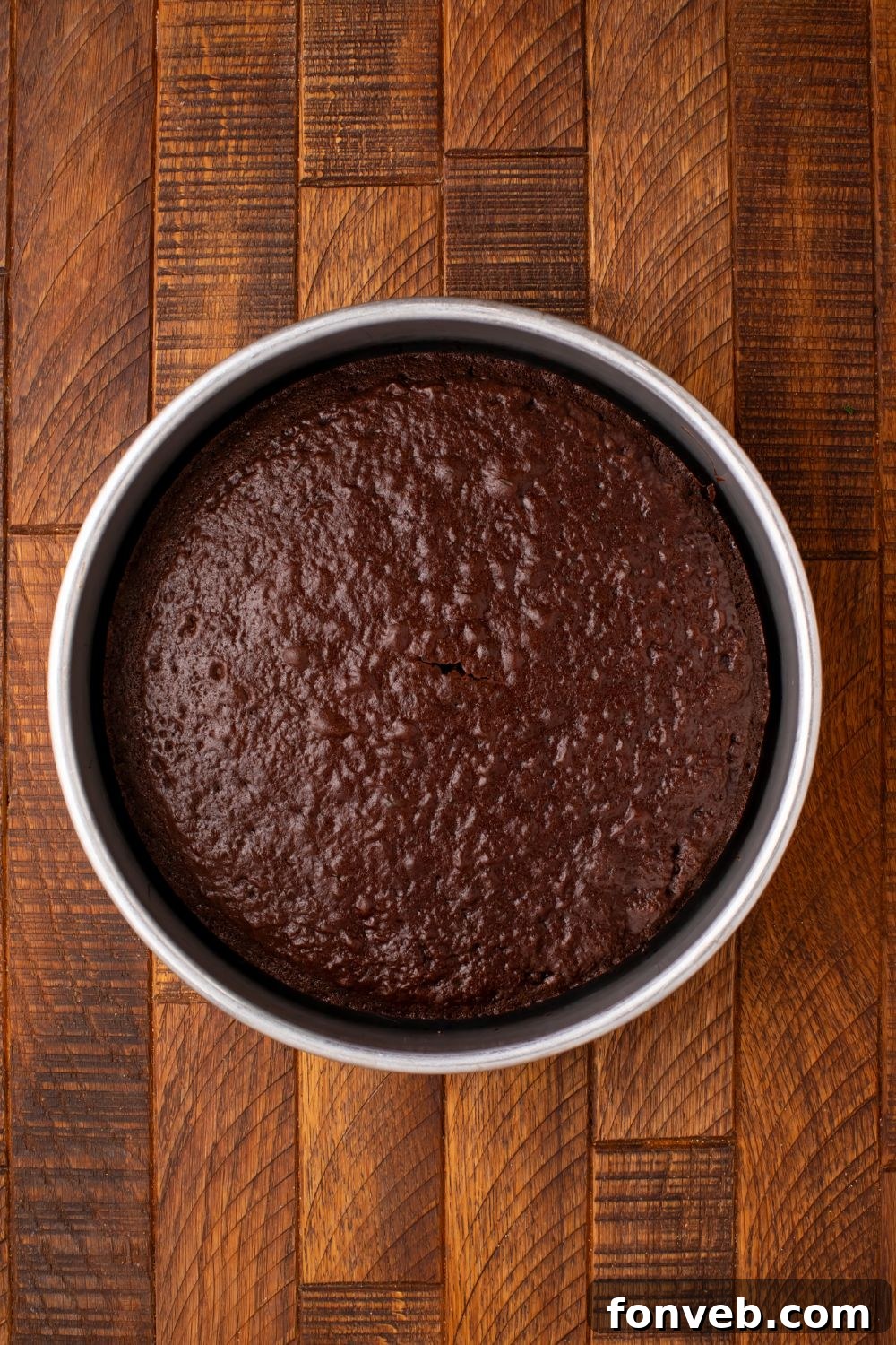 Purrfectly Simple 4-Ingredient Black Cat Halloween Cake 5 Freshly baked chocolate cake in a round pan, cooling