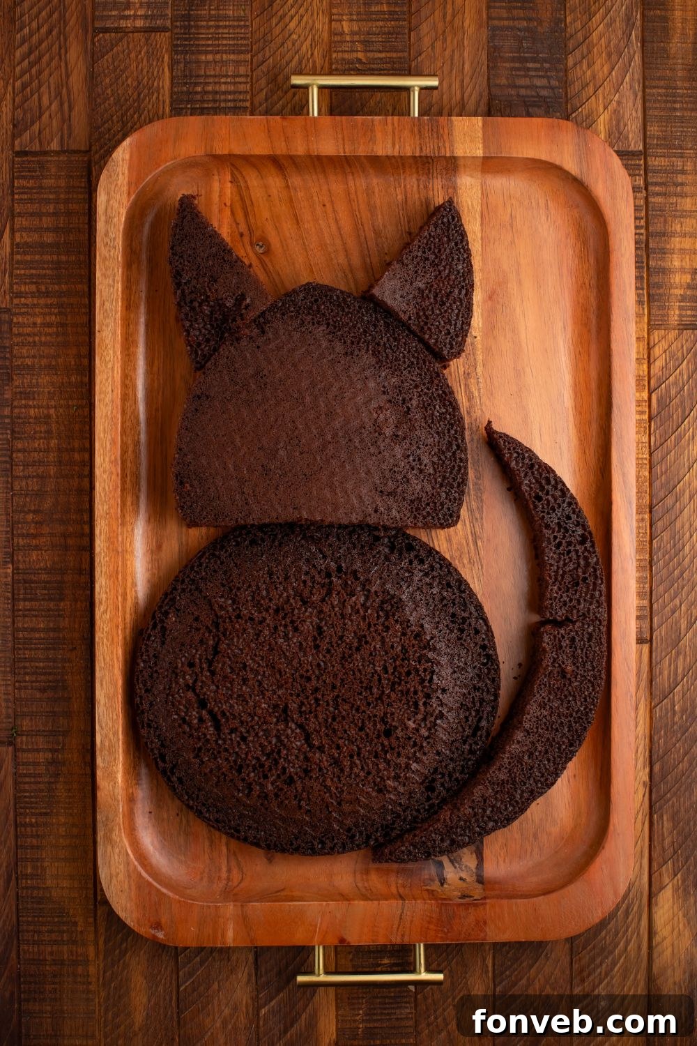 Purrfectly Simple 4-Ingredient Black Cat Halloween Cake 7 Cake pieces arranged on a serving tray to resemble a cat, ready for frosting