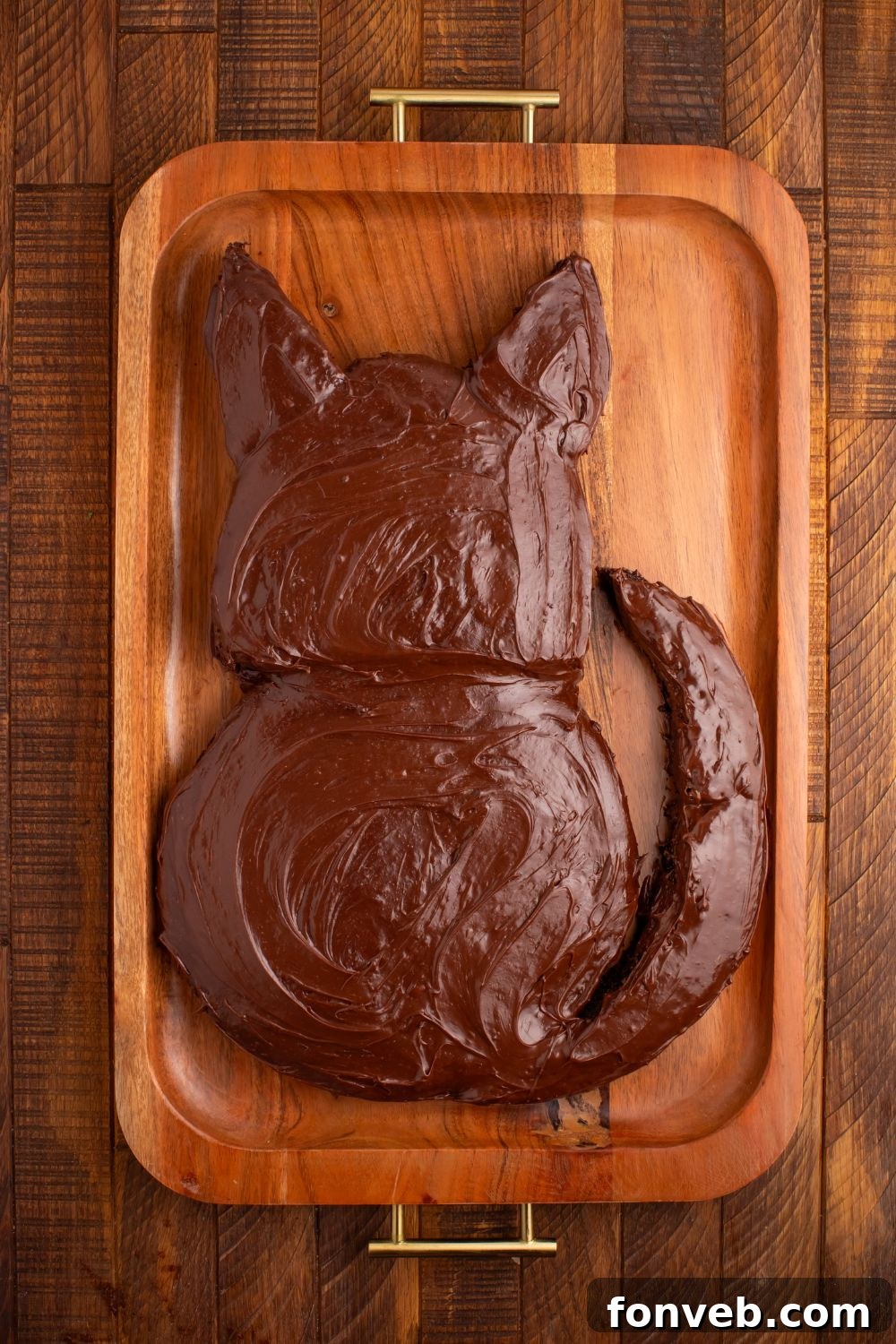 Purrfectly Simple 4-Ingredient Black Cat Halloween Cake 8 Chocolate frosted Easy Halloween Black Cat Cut Out Cake that isn't decorated yet, showcasing its smooth black coating