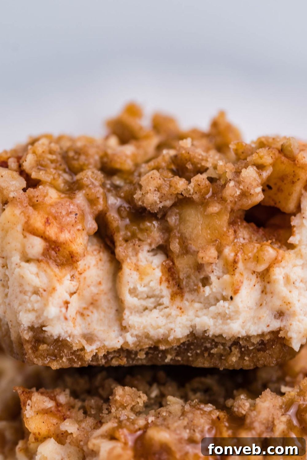 close up of Apple Crisp Cheesecake Bite with part of a bite taken out of it 
