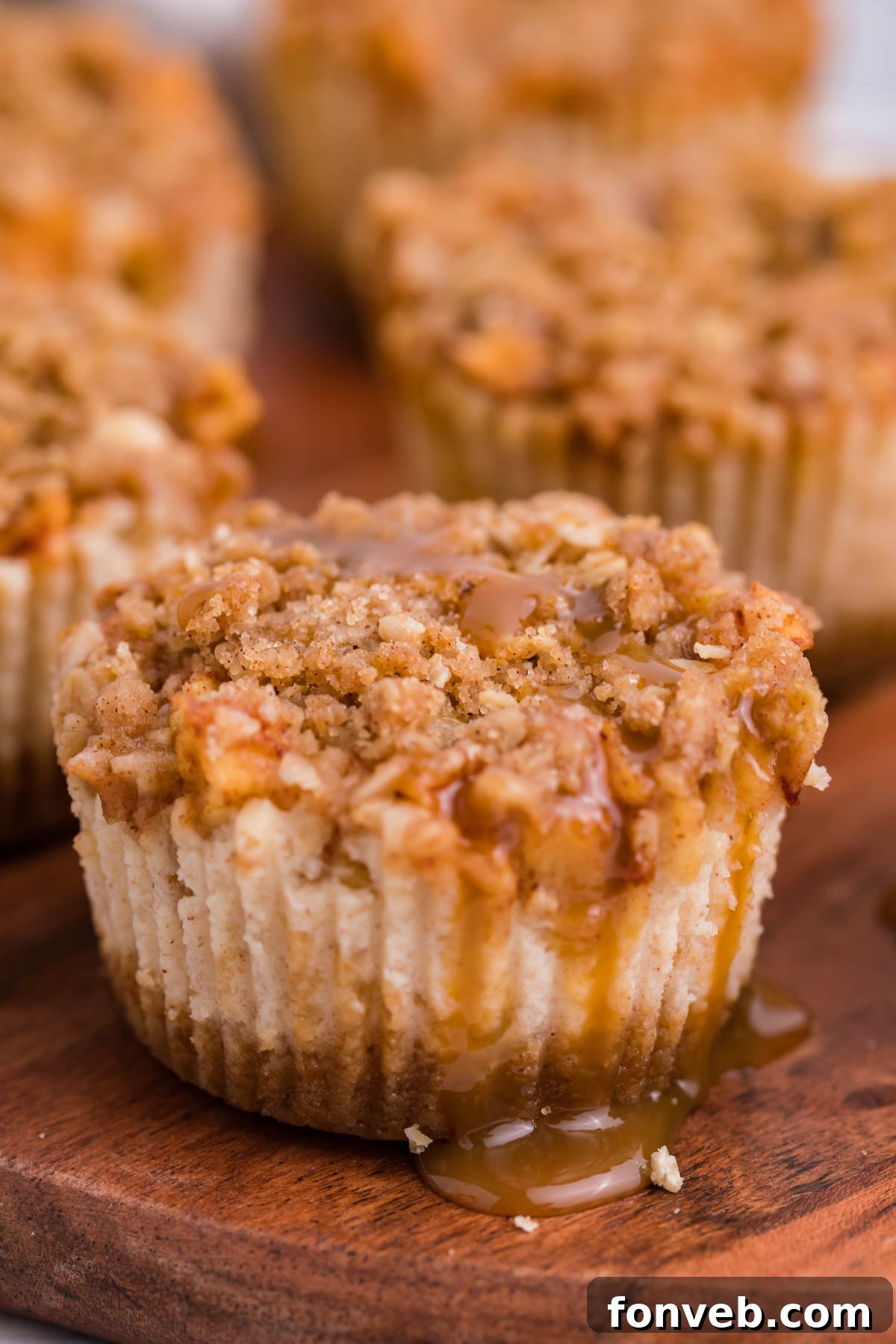 close up of the Apple Crisp Cheesecakes with drizzled caramel on top