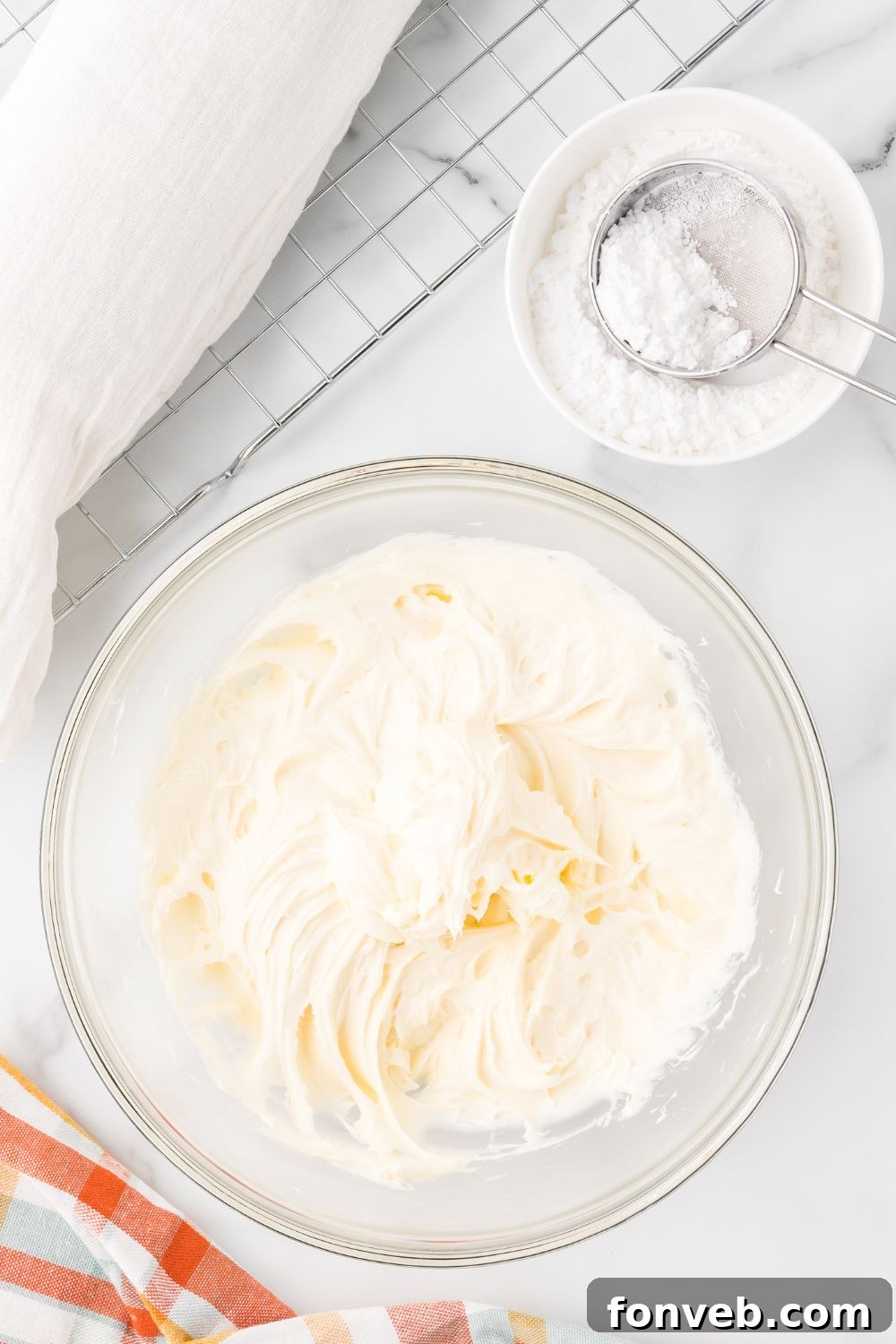 Classic Spiced Pumpkin Roll 14 cream cheese filling in a glass bowl sitting on a marble counter