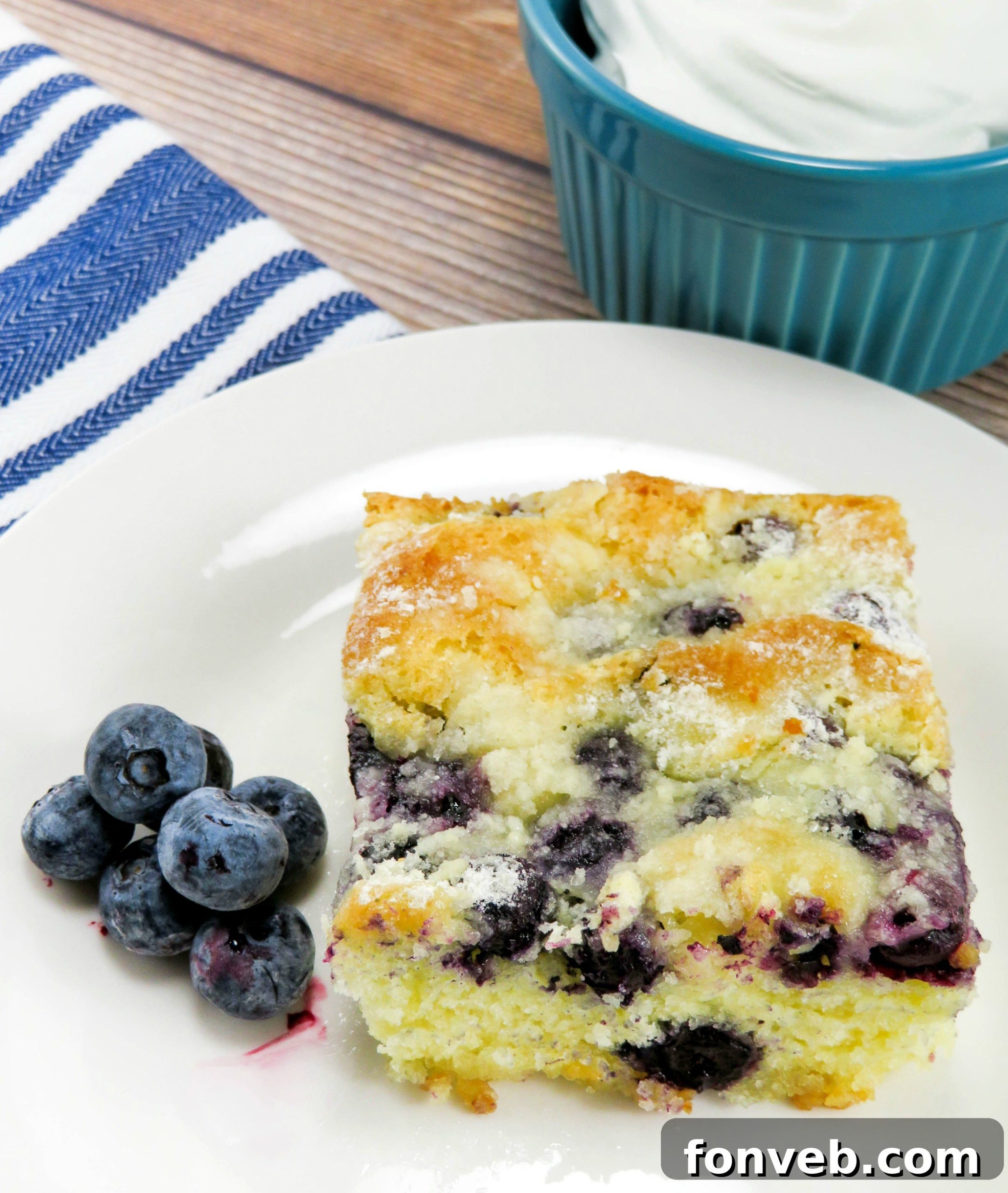 A beautifully plated slice of blueberry butter cake, ready to be enjoyed as a dessert
