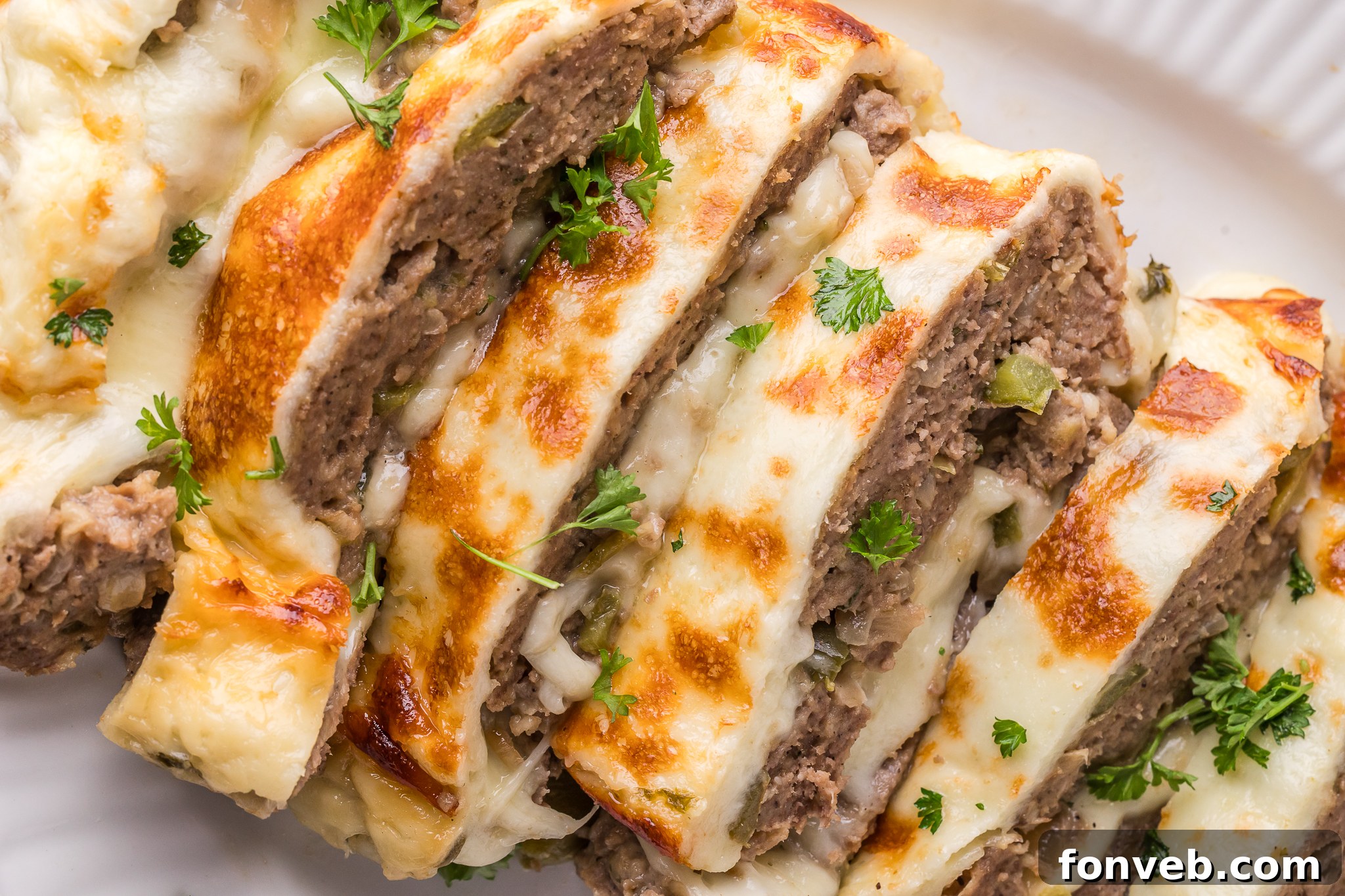 Philly Cheesesteak Meatloaf sliced on a white serving plate 