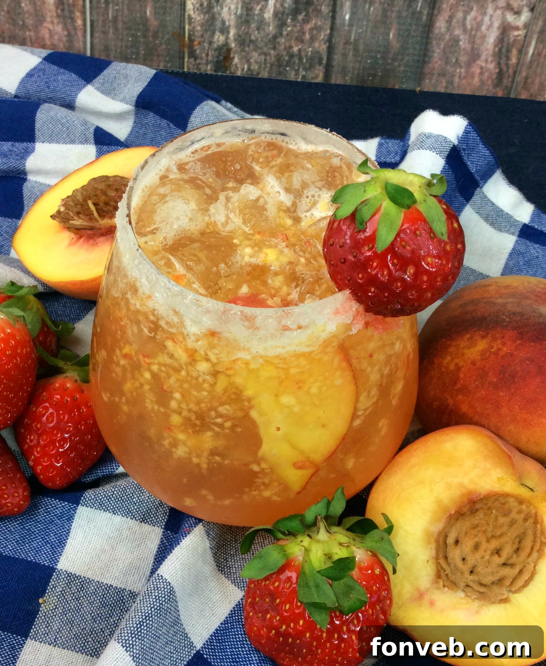 The Georgia Peach Flirt 2 Freshly made peach cocktail in a glass, garnished with peach slices.