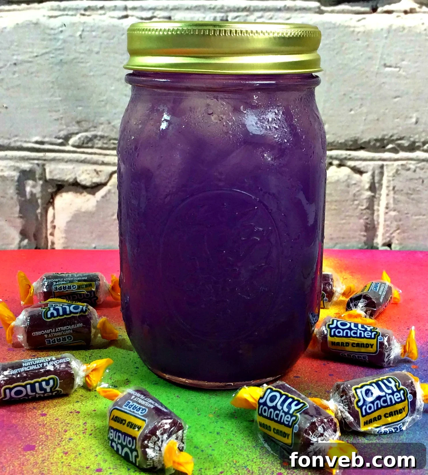 Two jars of vibrant purple Grape Jolly Rancher Moonshine with candy