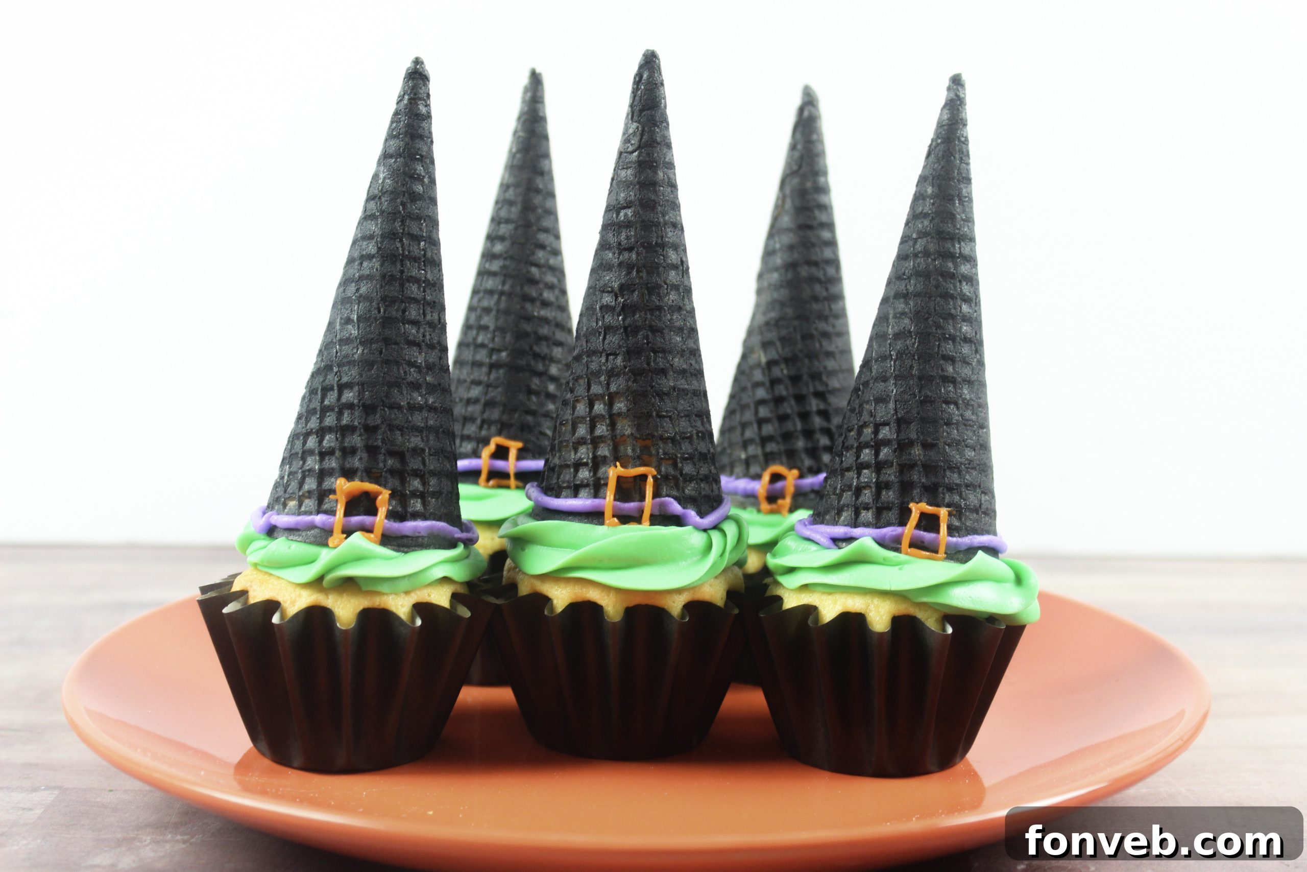Wicked Witch Hat Cupcakes 2 Autumn leaves and Halloween decor create a magical atmosphere, perfect for baking spooky treats.