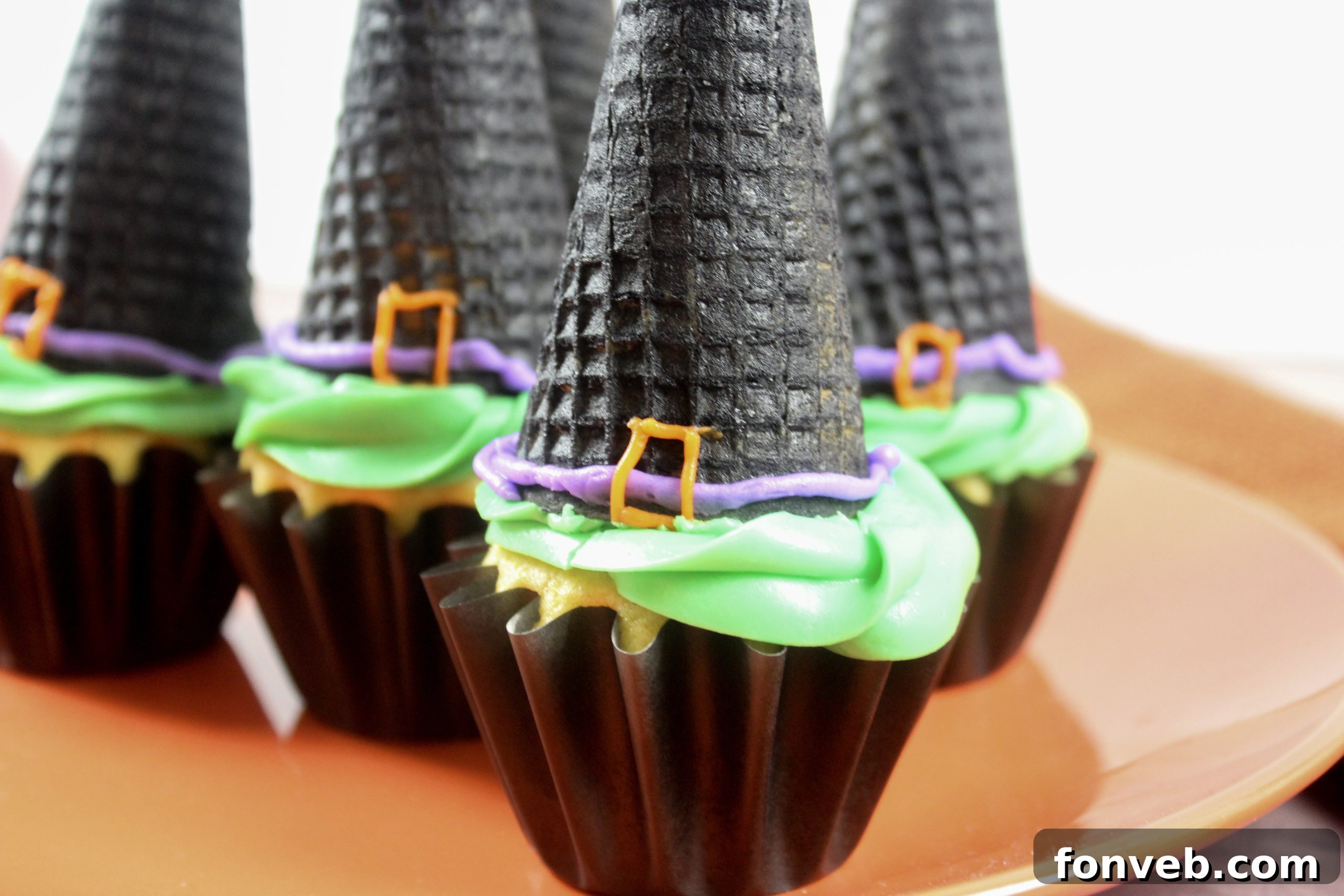 Wicked Witch Hat Cupcakes 12 A display of fully assembled witch hat cupcakes, vibrant and ready to be served.