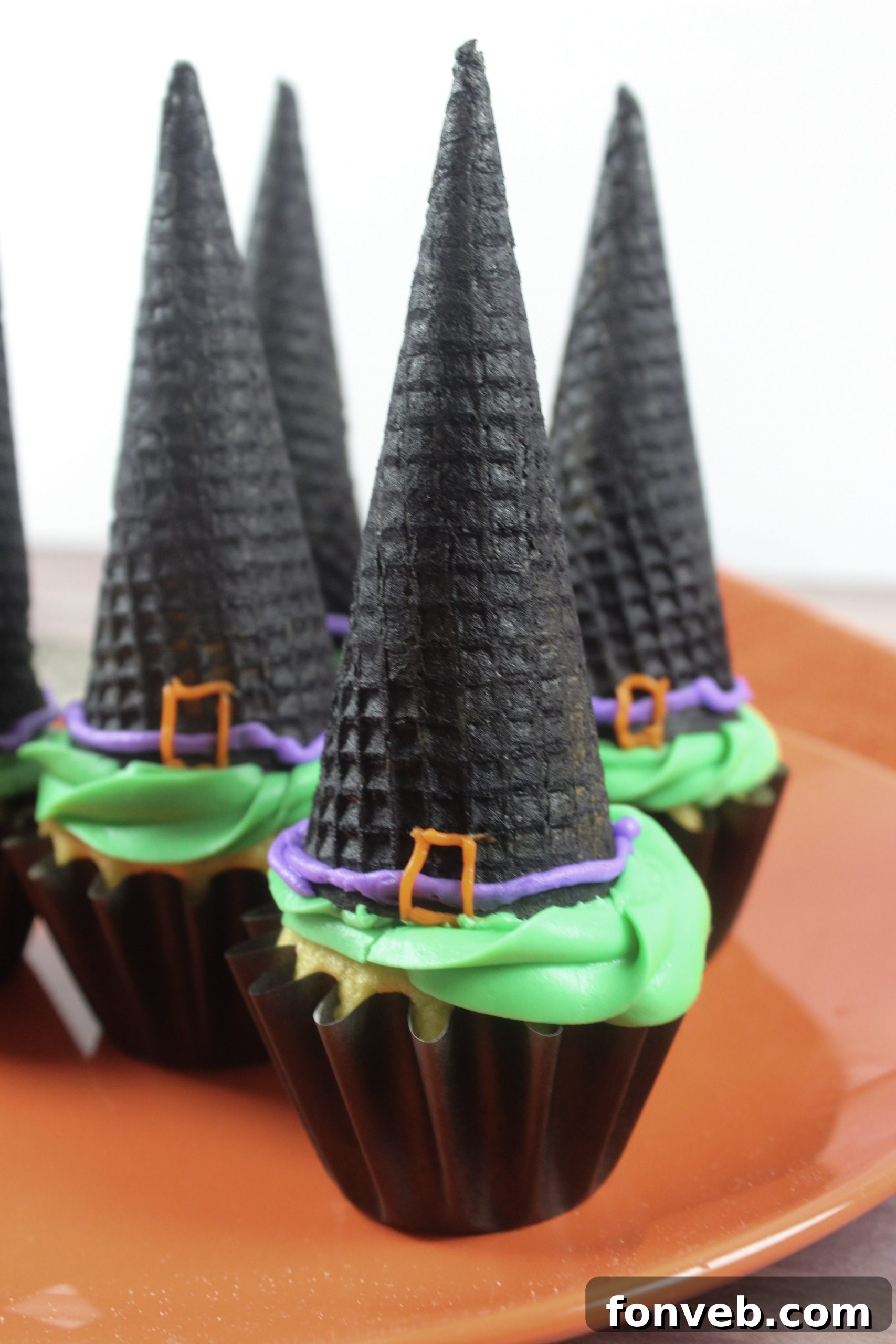 Wicked Witch Hat Cupcakes 13 An overhead shot showcasing a dozen witch hat cupcakes arranged in a festive Halloween display.