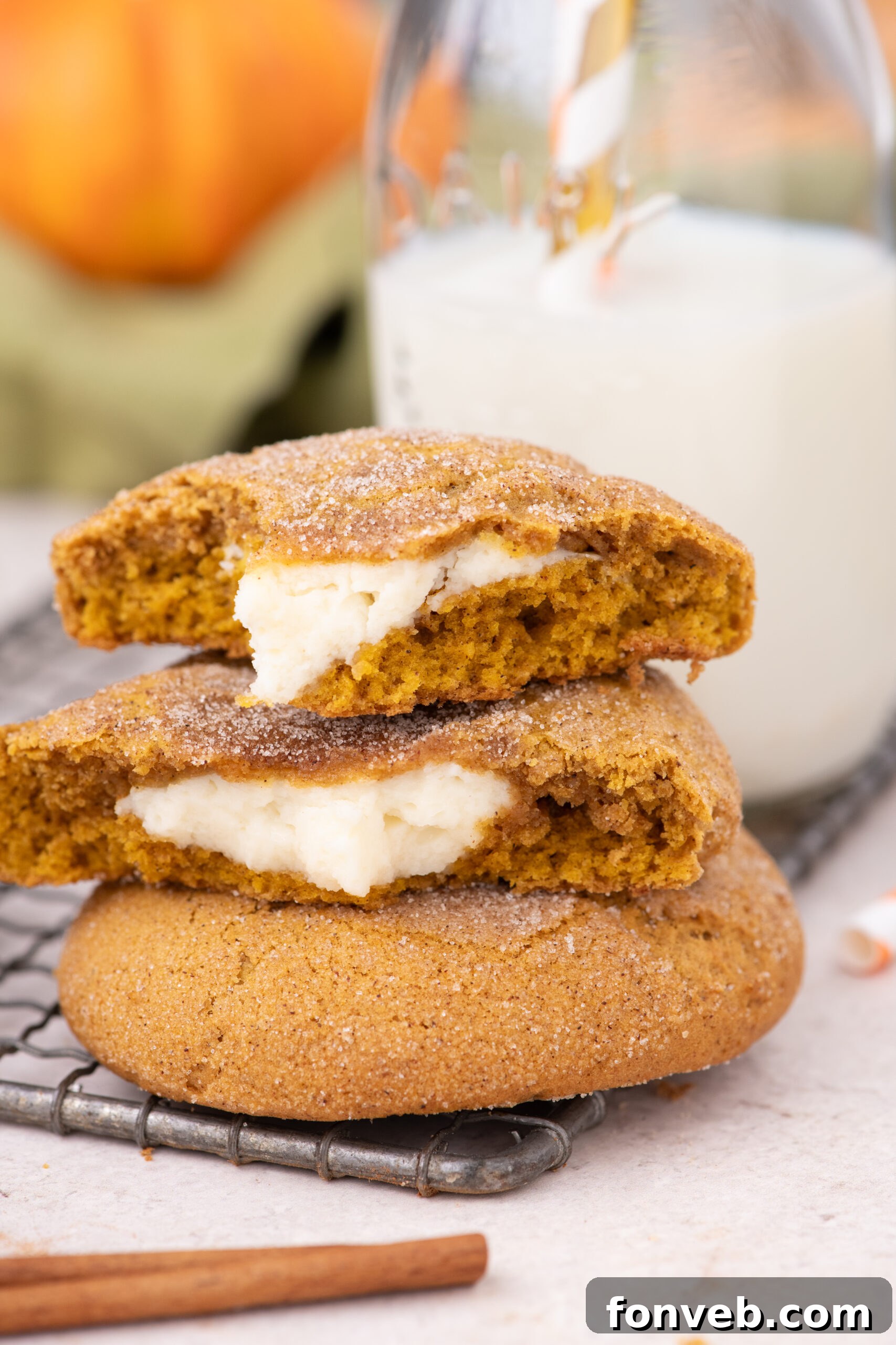 Pumpkin Cheesecake Cookies stacked on a cooling rack