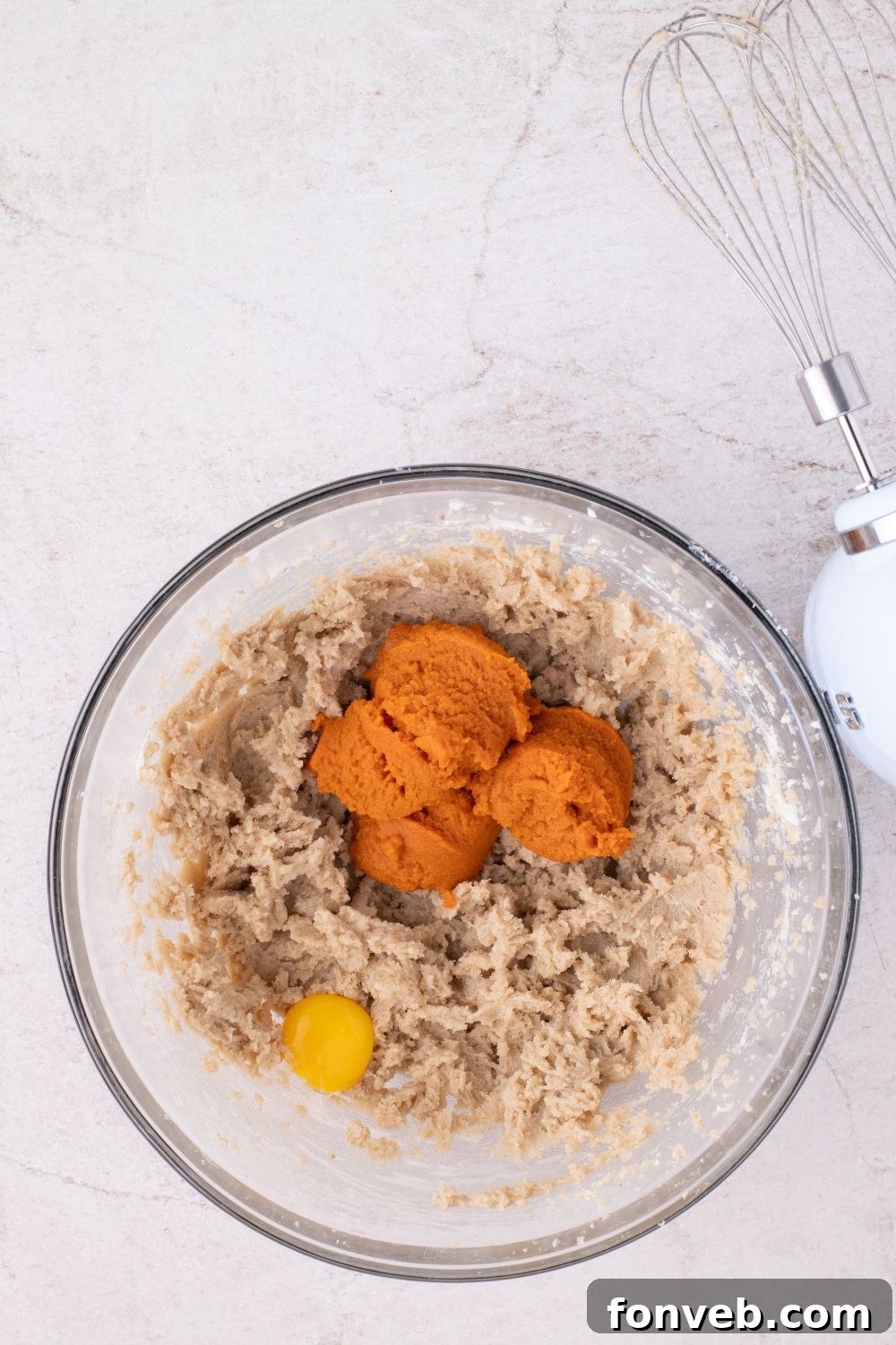glass bowl of raw pumpkin batter in bowl for making pumpkin cookies 