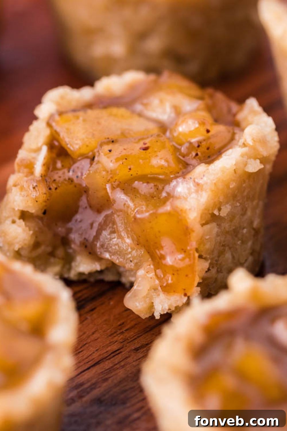 Mini Apple Crisp Bites on table and the one in the center has a bite taken out of it 
