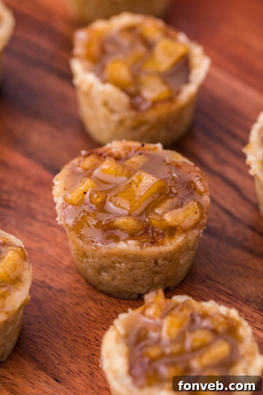 Mini Apple Crisp Bites placed evenly on table with bites all around the wooden table 