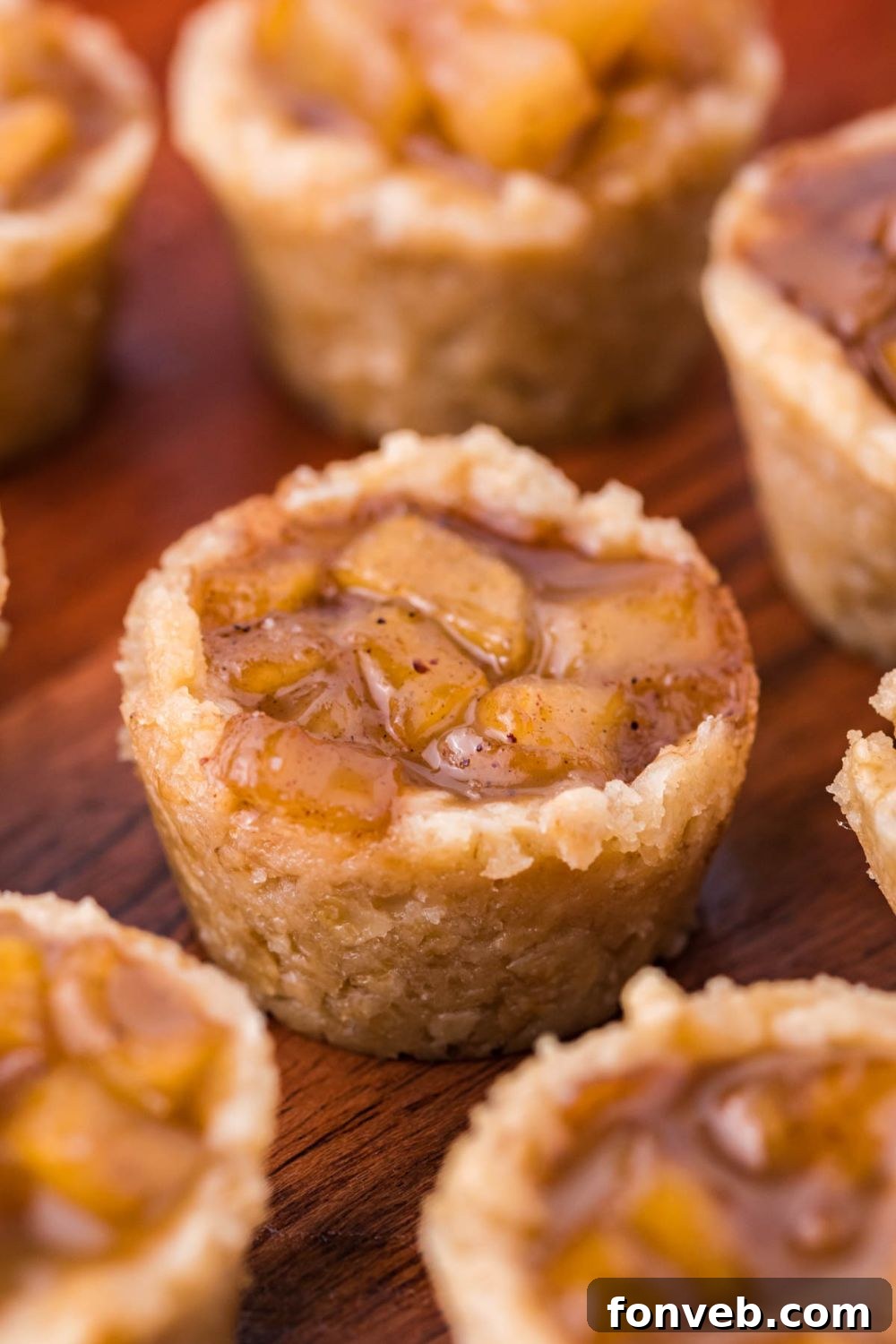 Mini Apple Crisp Bites placed close by one another on table in perfect cup shapes 