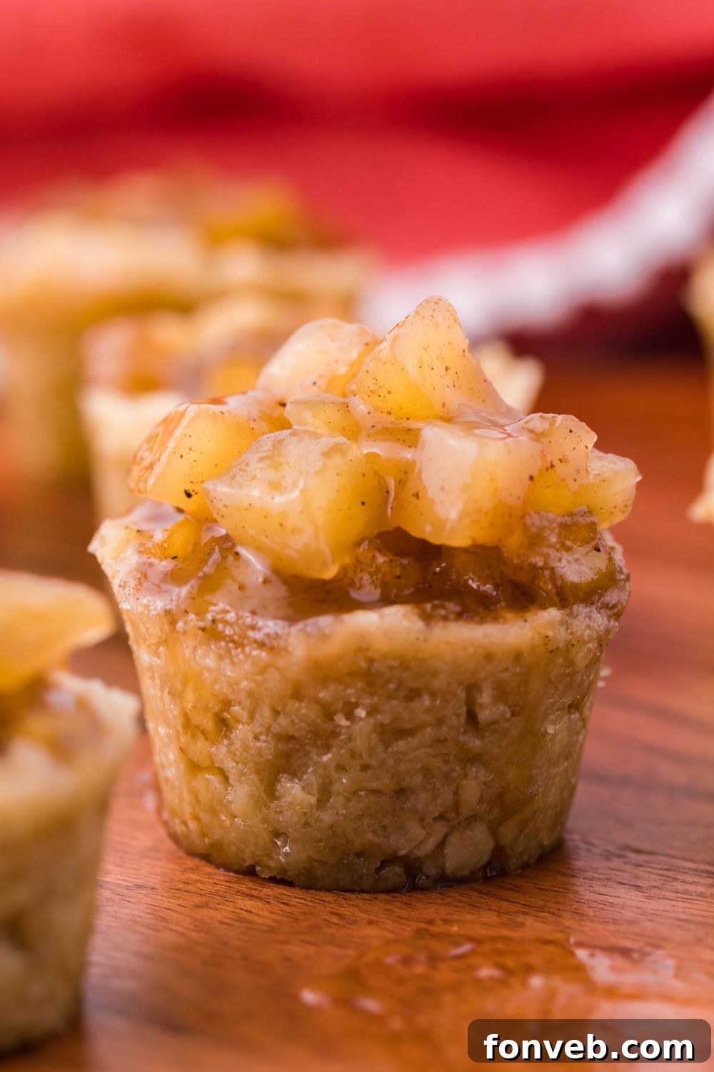 side view of a apple dessert cup with a red towel behind the background