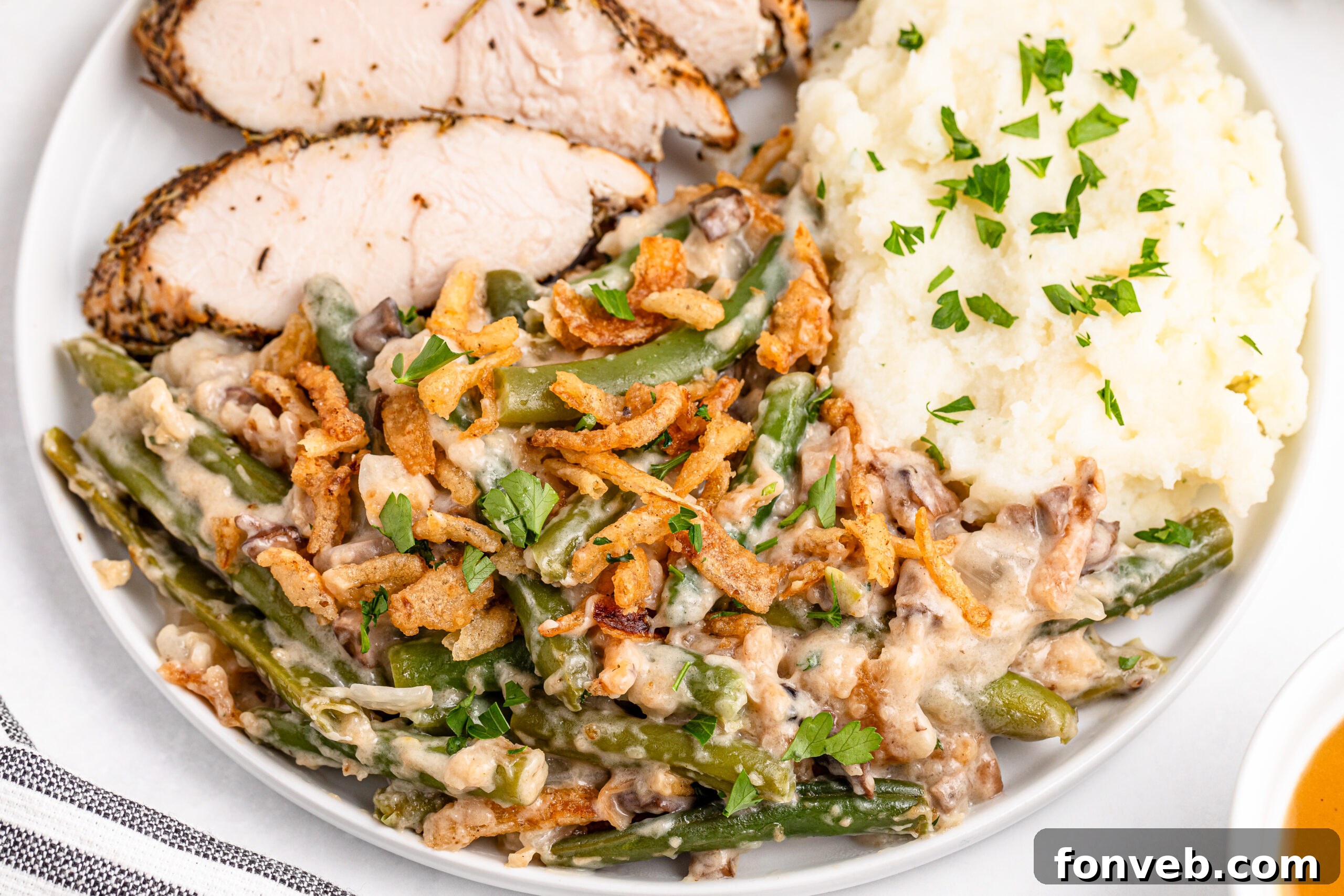 overhead shot of a plate of the Best Ever Green Bean Casserole with turkey and mashed potatoes