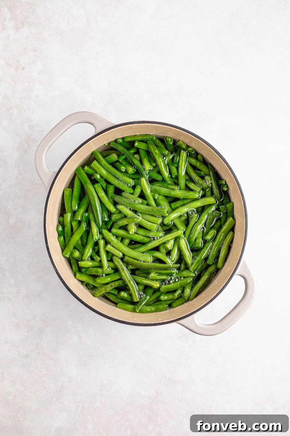 fresh green beans in a pot sitting on a table