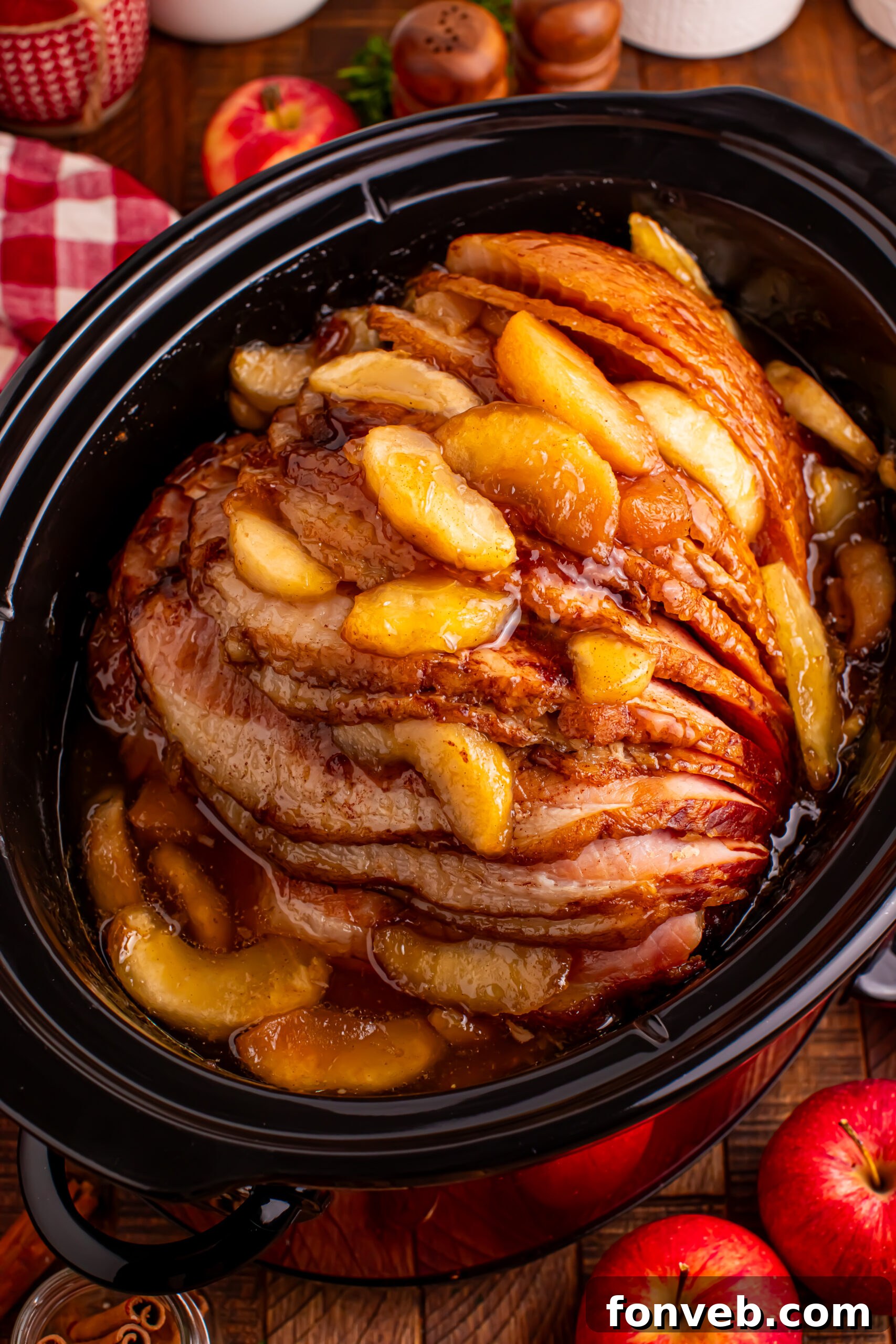 Tender and Juicy Slow Cooker Apple Glazed Ham 20 Up close shot of the Slow Cooker Apple Glazed Ham topped with apples