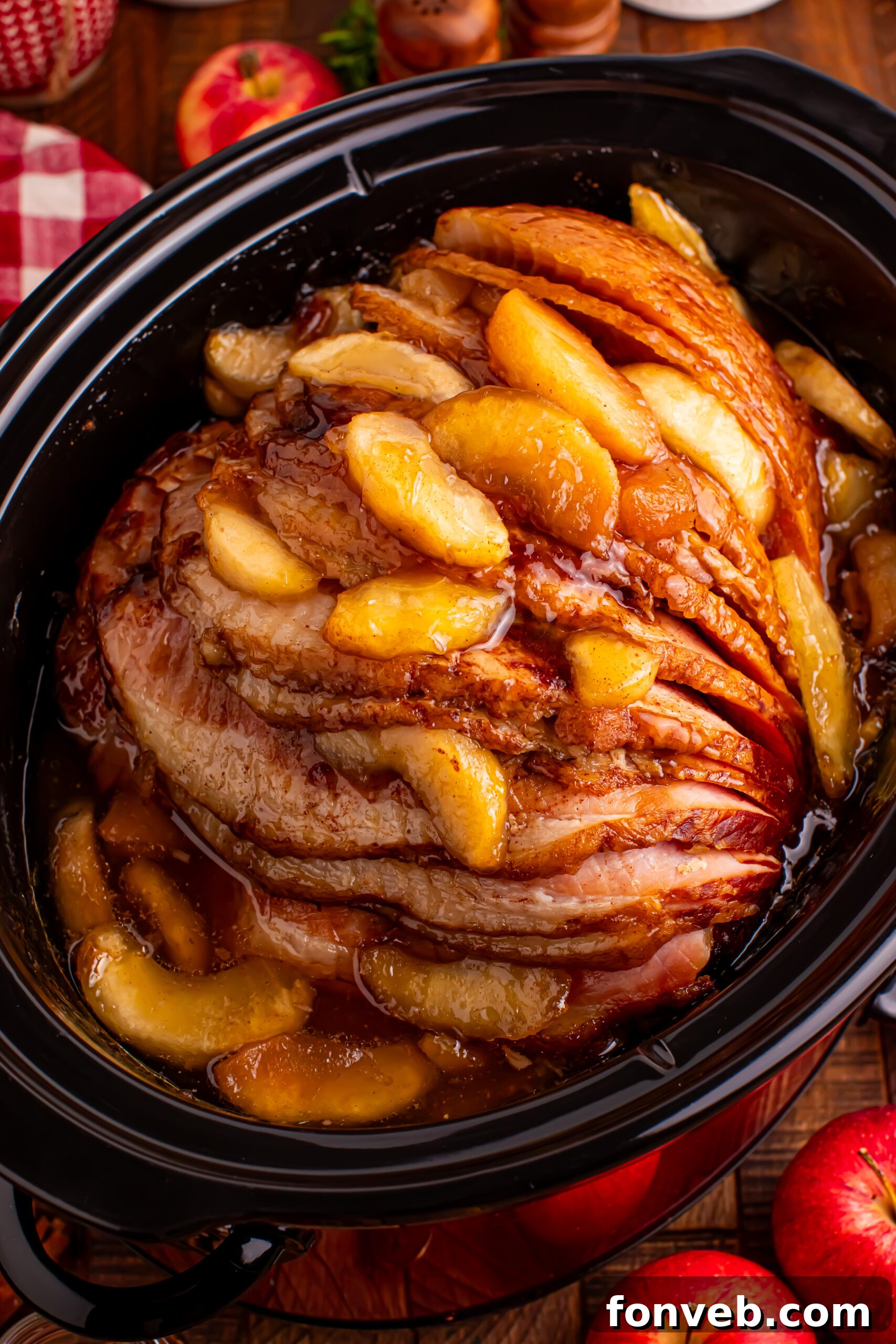 Tender and Juicy Slow Cooker Apple Glazed Ham 3 Slow Cooker Apple Glazed Ham in a black crock pot on a dark wood table