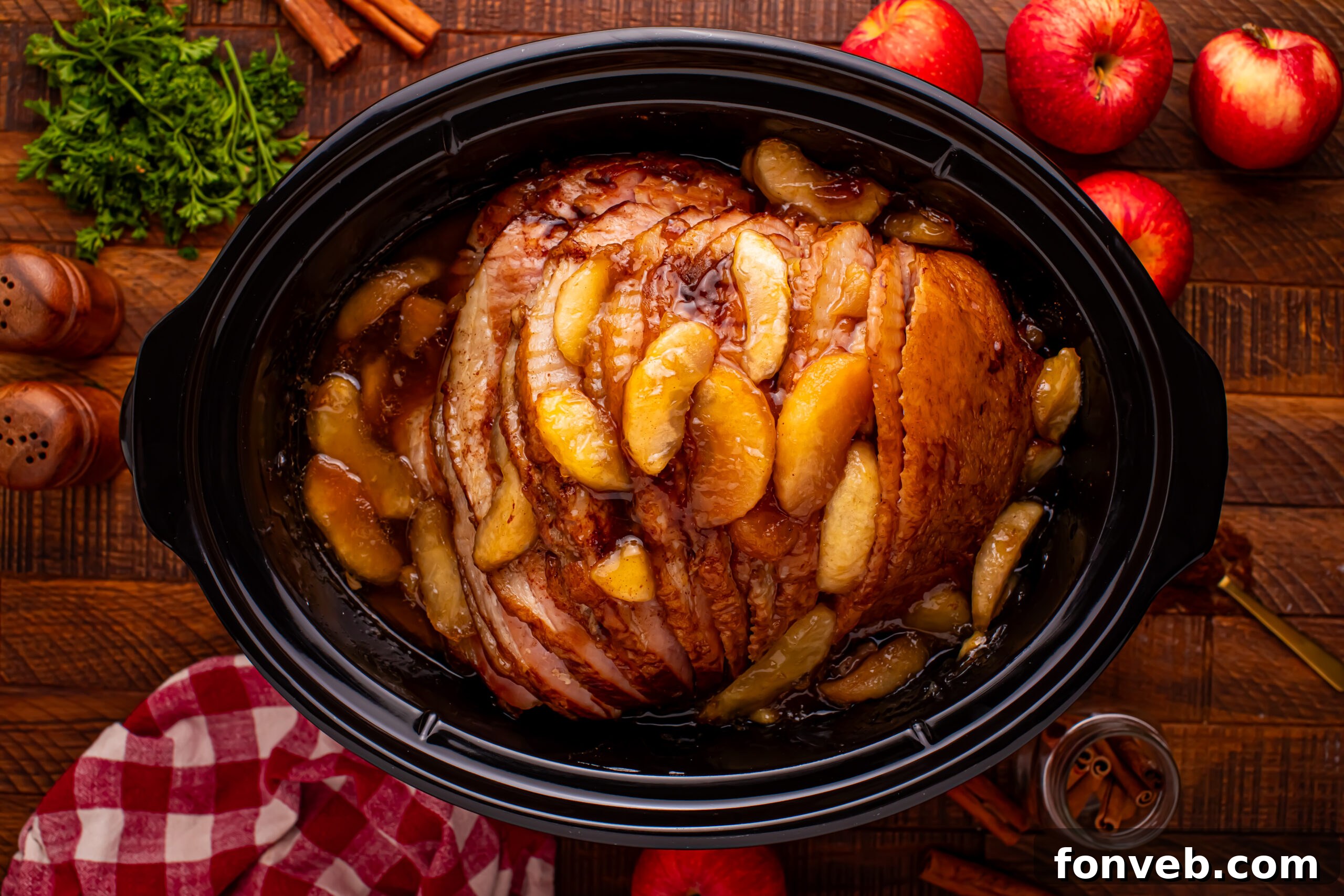 Tender and Juicy Slow Cooker Apple Glazed Ham 22 Slow Cooker Apple Glazed Ham in a black crock pot on a dark wood table
