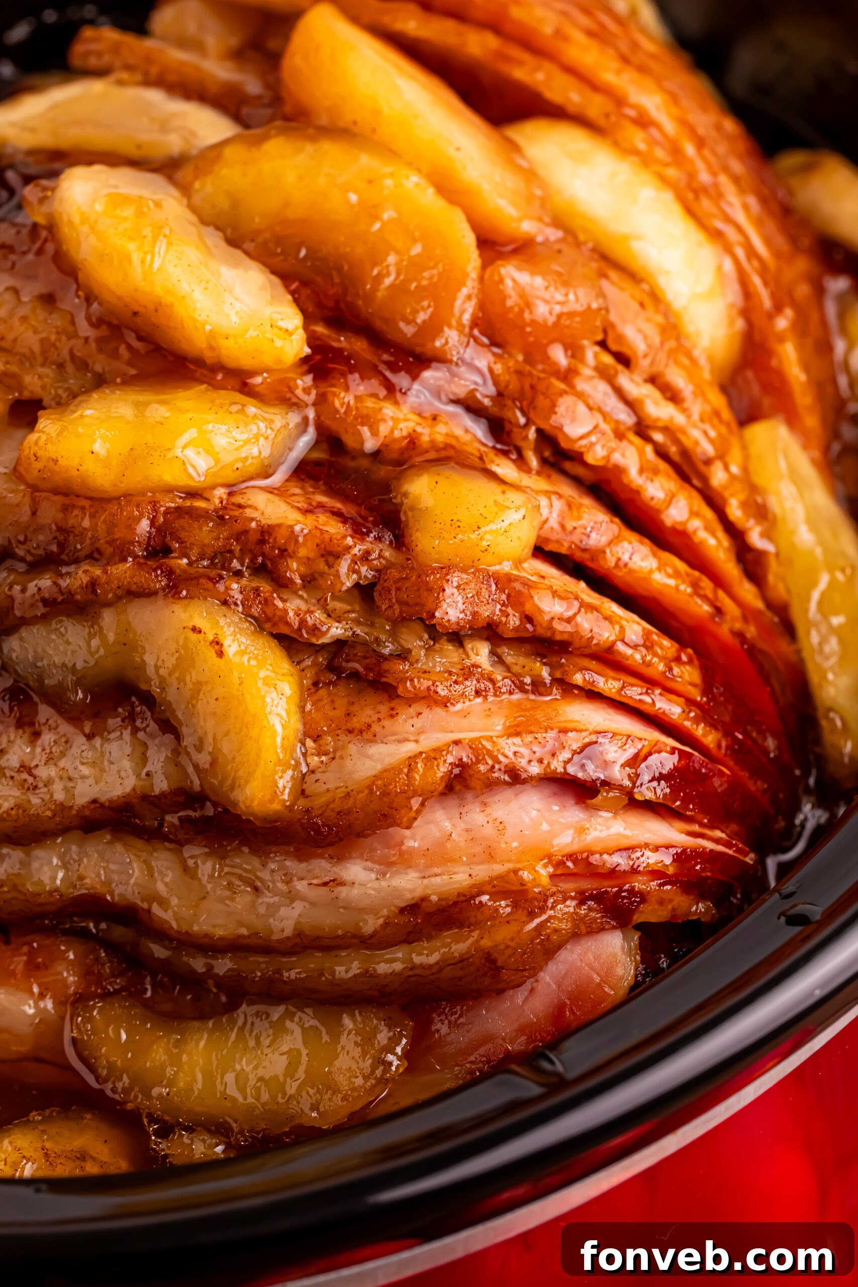 Tender and Juicy Slow Cooker Apple Glazed Ham 23 up close shot of the Slow Cooker Apple Glazed Ham in a black crock pot