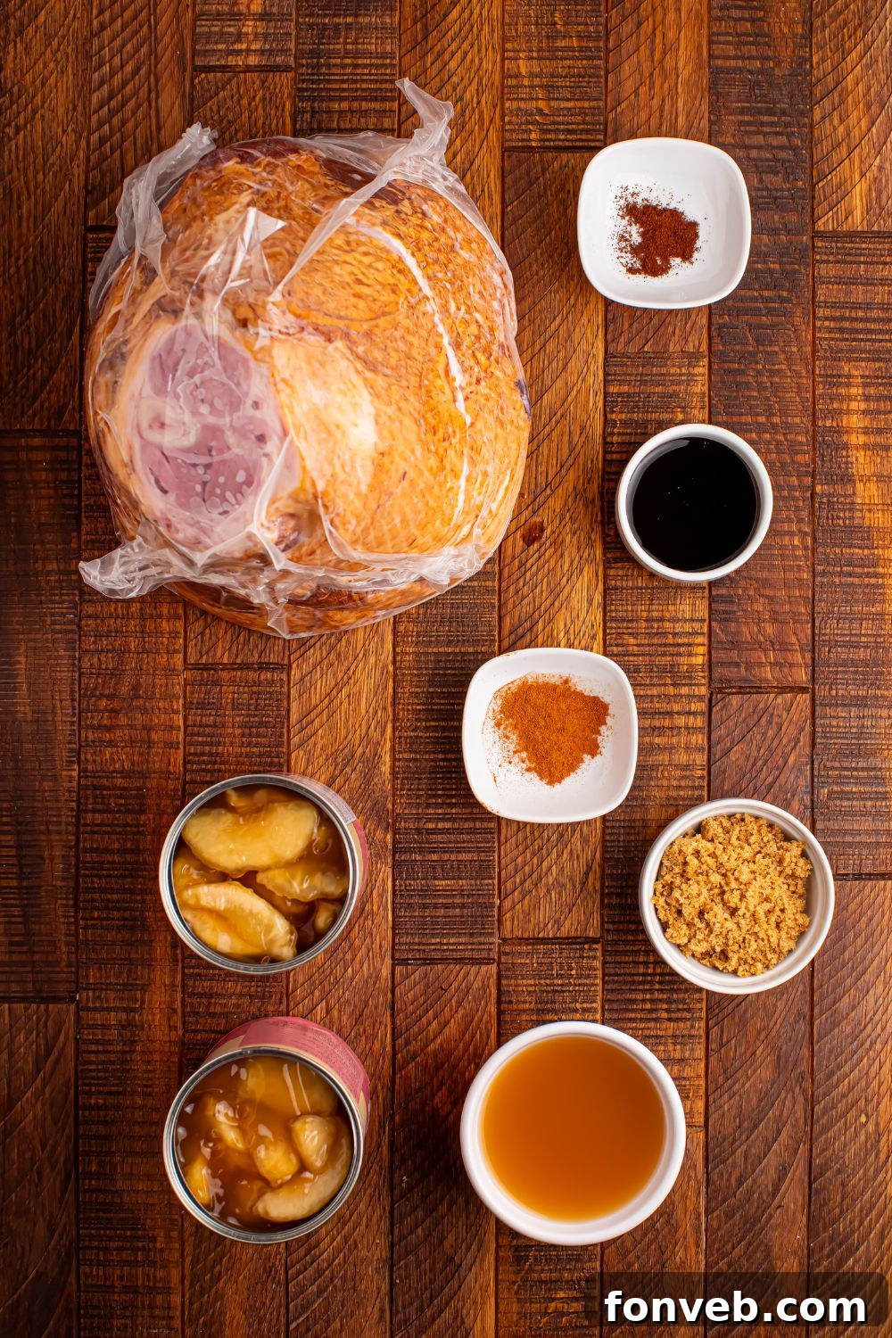 Tender and Juicy Slow Cooker Apple Glazed Ham 5 all the ingredients for apple glazed crockpot ham on a wooden table