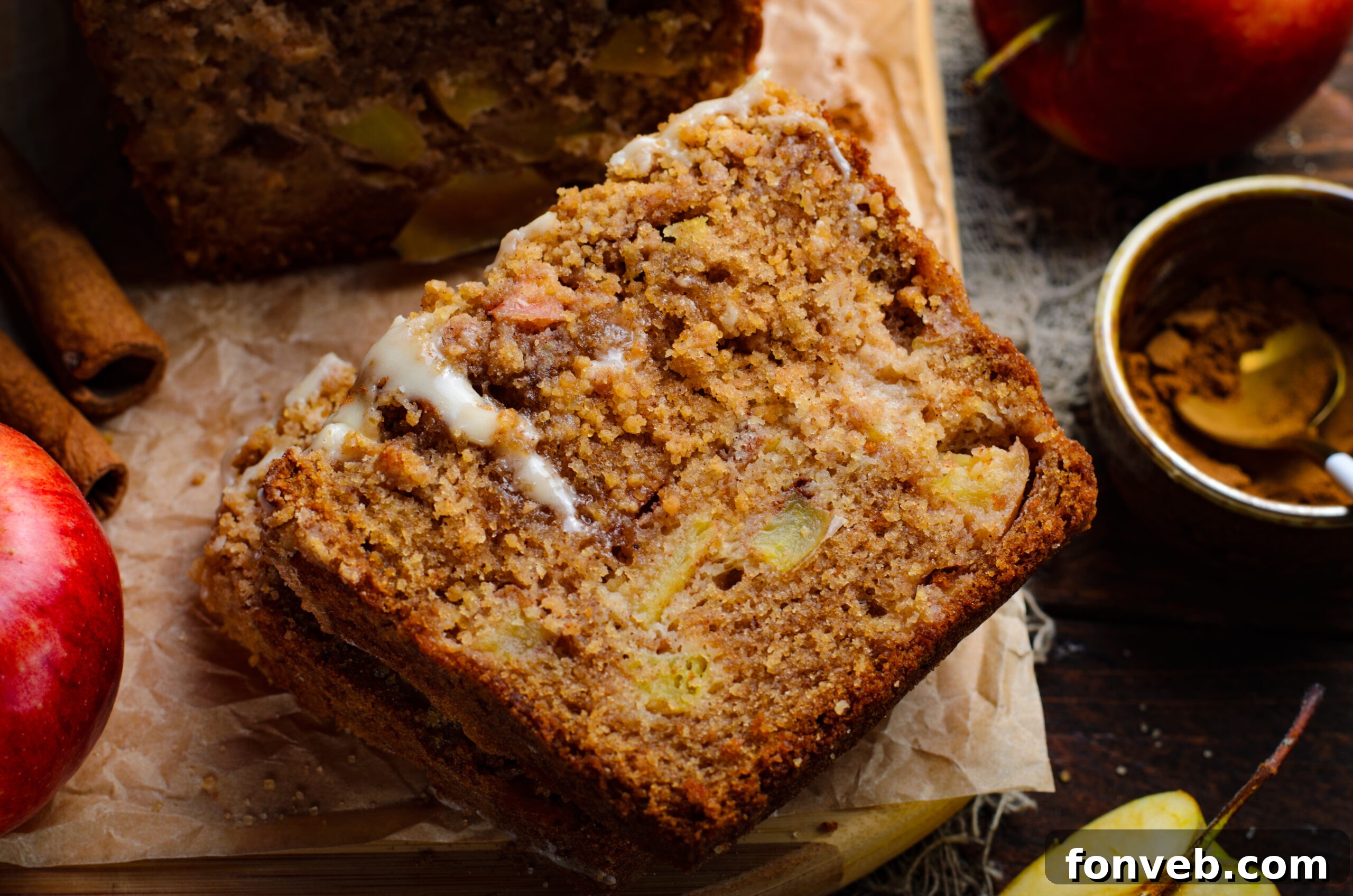 Quick Glazed Apple Cinnamon Loaf 19 A beautiful close-up of a slice of Apple Cinnamon Loaf Cake, showing its moist, tender interior filled with soft apple pieces, ready to be enjoyed.