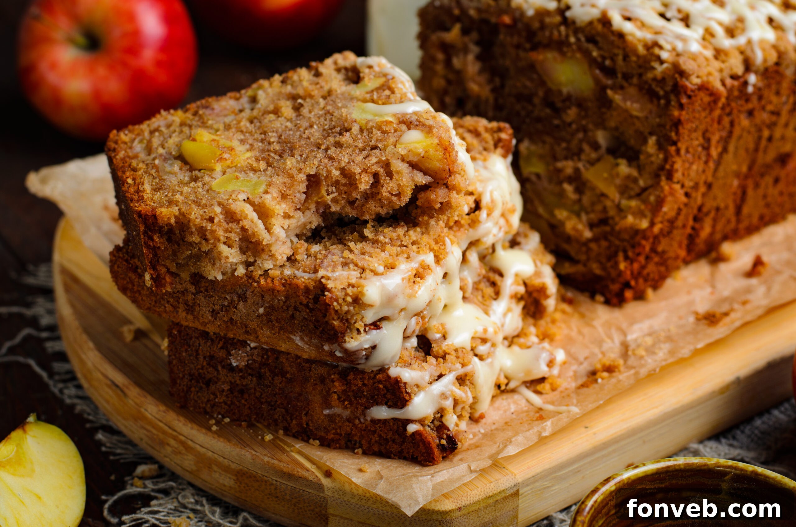 Quick Glazed Apple Cinnamon Loaf 25 A close-up view of four perfectly stacked slices of Apple Cinnamon Loaf Cake, each generously covered with a sweet, flowing glaze, ready for an indulgent treat.