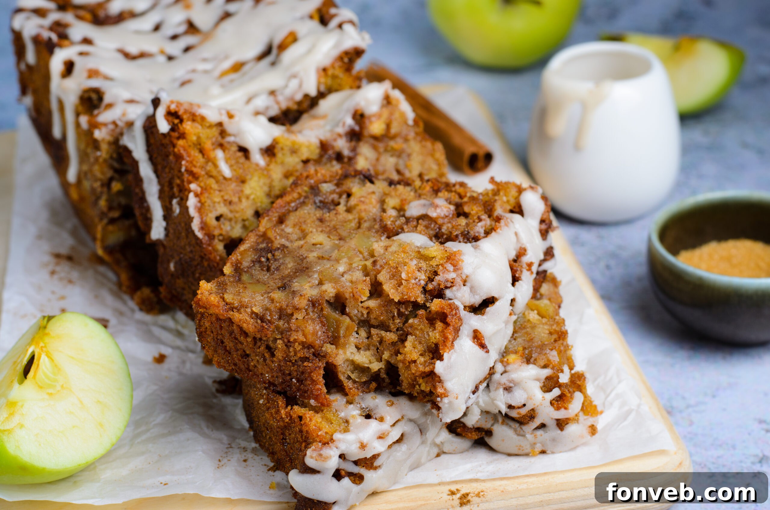 two slices of Amish Apple Fritter Bread on a wooden cutting board 