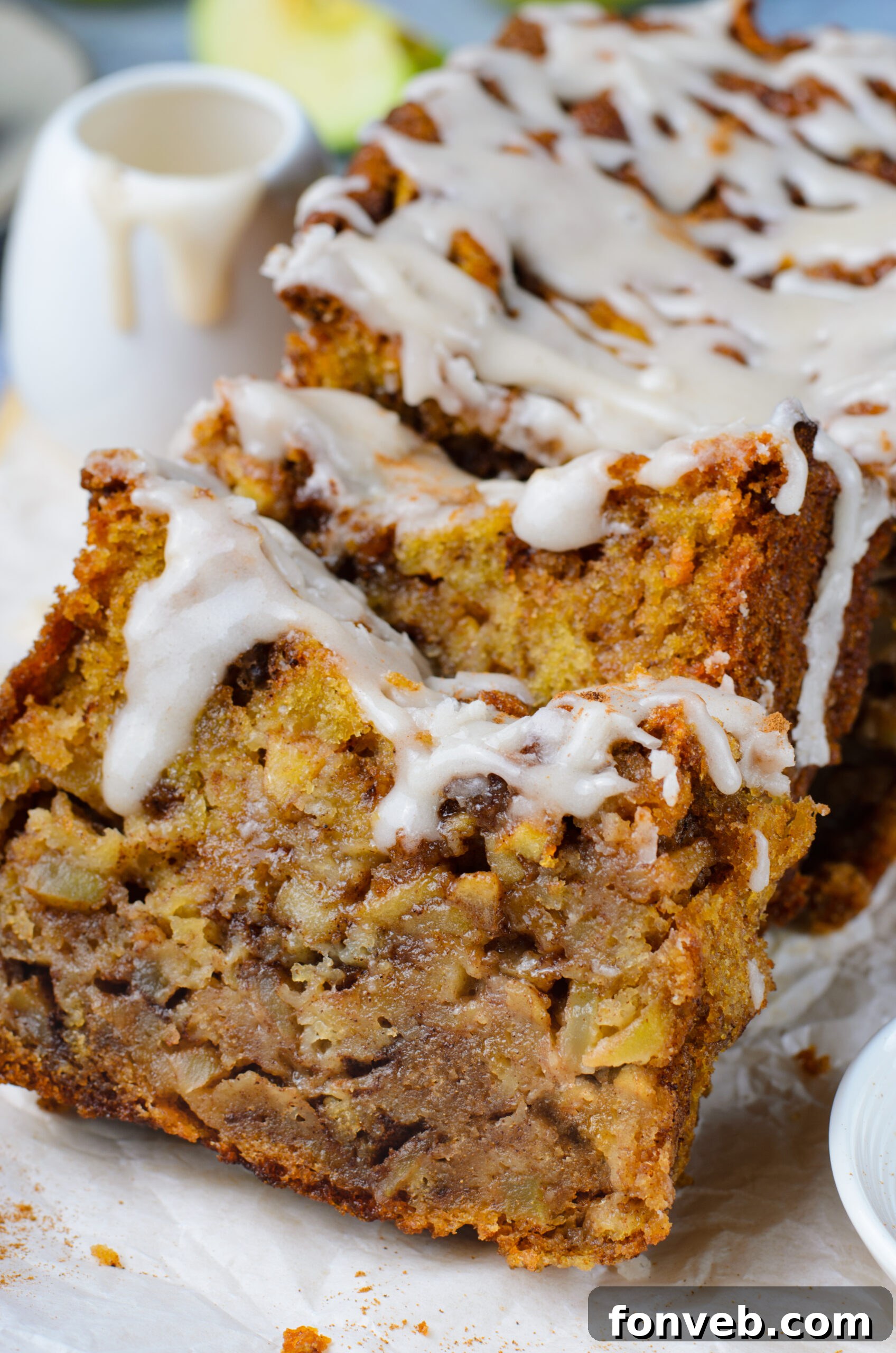 two slices of Amish Apple Fritter Bread up close sliced and covered in glaze