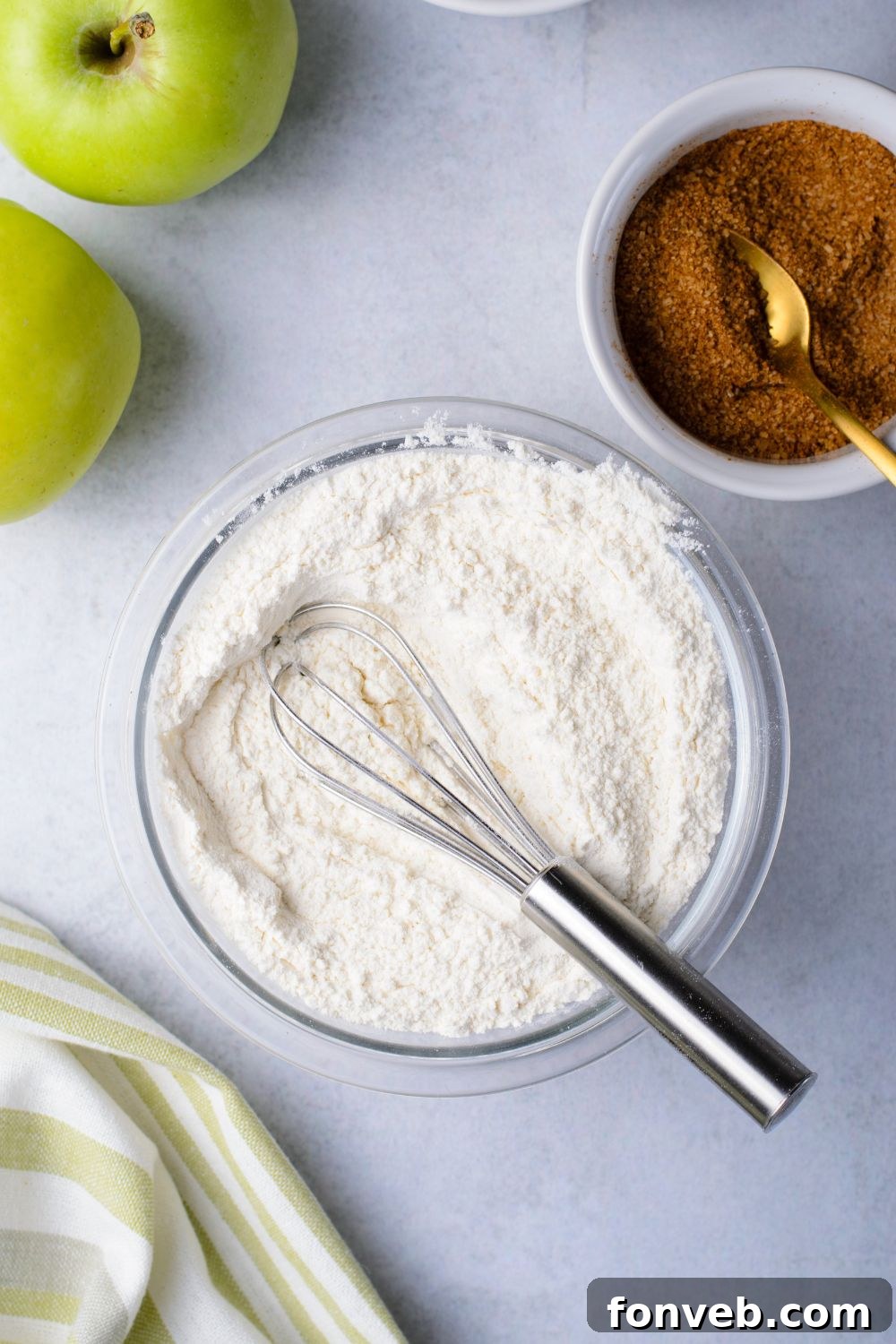 dry ingredients in a bowl for making amish bread and a bowl of cinnamon sugar mixture to side in another bowl 