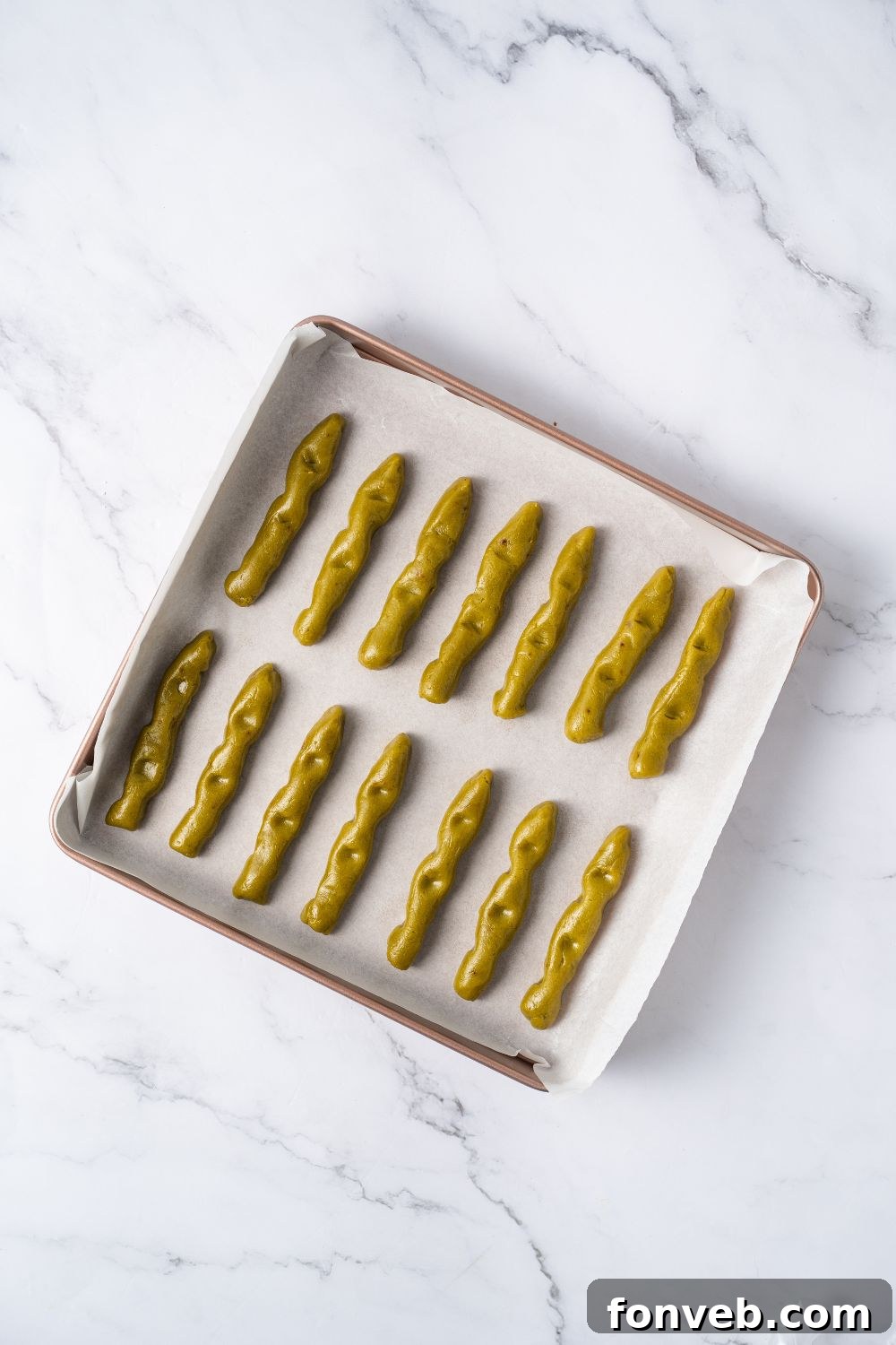 Witch Finger Cookies A Ghoulishly Fun Halloween Bake 11 Witch Finger Cookie dough in strips on a baking dish with parchment paper