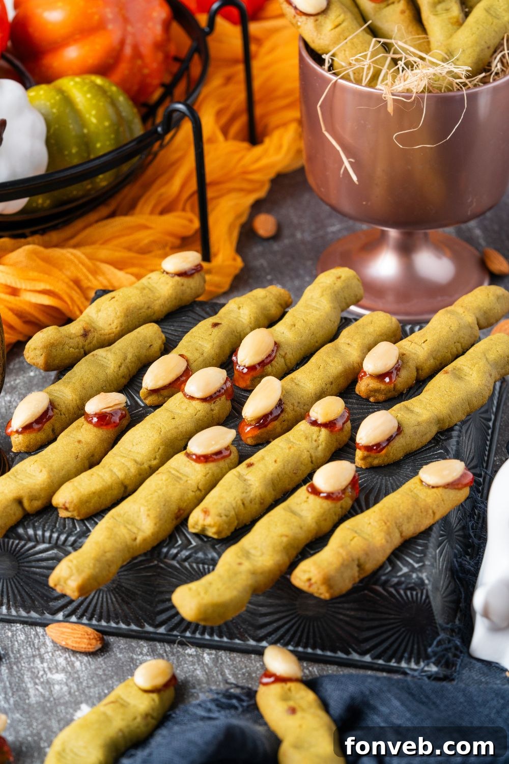 Witch Finger Cookies A Ghoulishly Fun Halloween Bake 16 witches finger on a cooling rack on table with fall themed items behind it on table