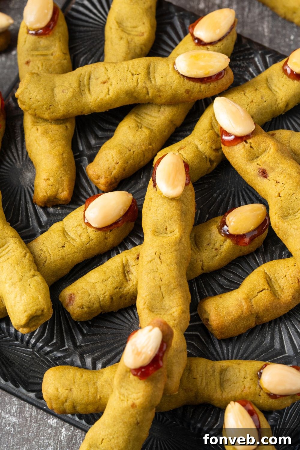 Witch Finger Cookies A Ghoulishly Fun Halloween Bake 19 Witch Finger Cookies scattered all around the table and placed on a black tray