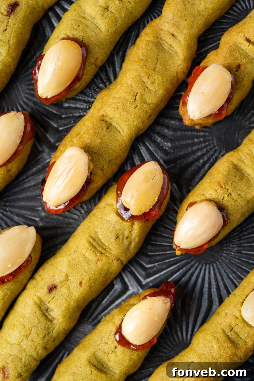 Witch Finger Cookies A Ghoulishly Fun Halloween Bake 20 Witch Finger Cookies placed neatly on a black tray on table to see the detail of each cookie