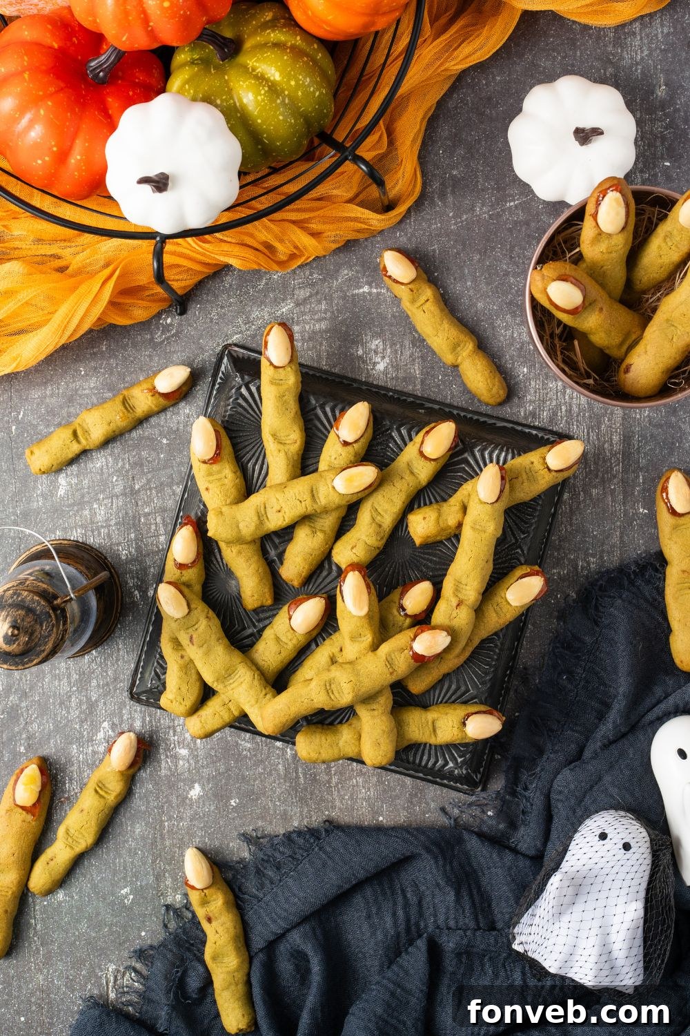 Witch Finger Cookies A Ghoulishly Fun Halloween Bake 3 Witch Finger Cookies in a square plate on table with more scattered around the table with Halloween decor all around table