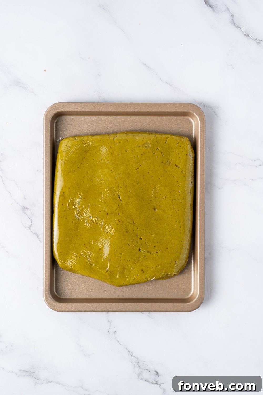 Witch Finger Cookies A Ghoulishly Fun Halloween Bake 9 pistachio cookie dough shaped in a square on a baking sheet on table