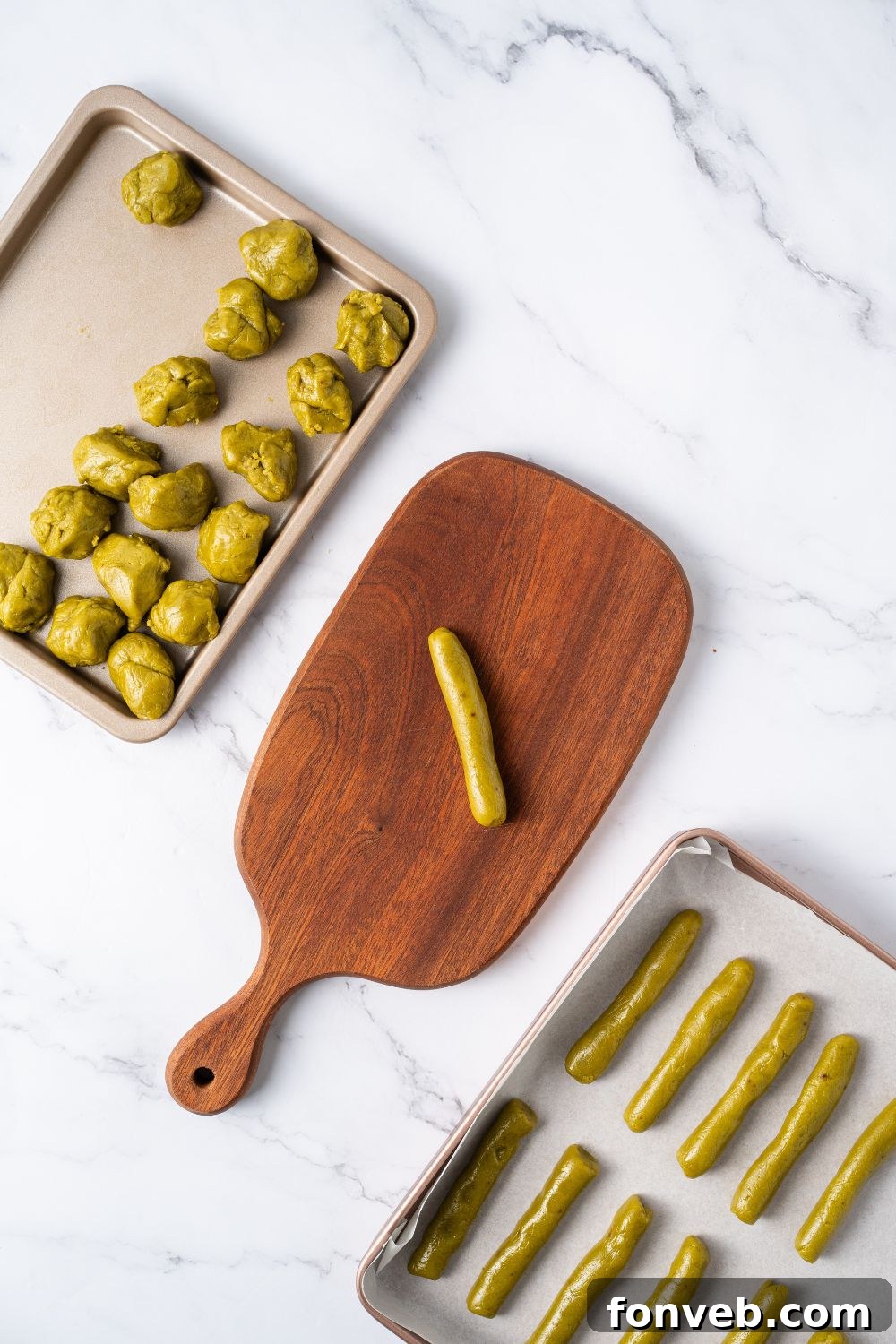 Witch Finger Cookies A Ghoulishly Fun Halloween Bake 10 Witch Finger Cookie dough on a tray with a wooden tray with a shape of fingers and another tray with balls of cookie dough