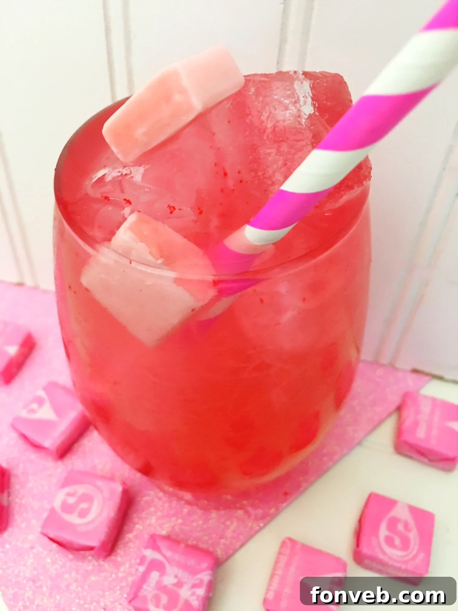 Candy Pink Burst Cocktail 2 Refreshing Pink Starburst Cocktail garnished with Starburst candies in a tall glass.