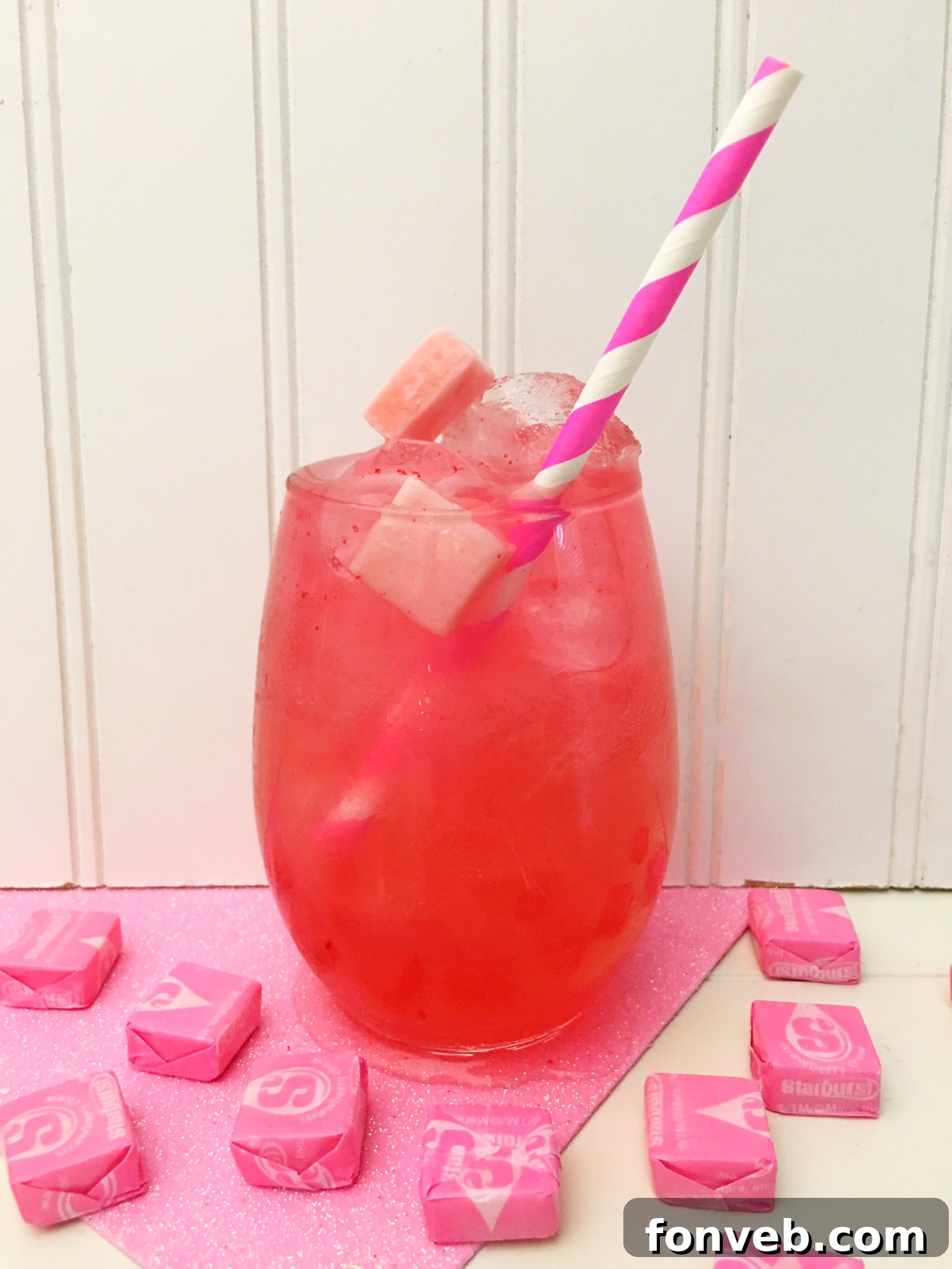 Candy Pink Burst Cocktail 4 Another perspective of the Pink Starburst Cocktail, showcasing its beautiful pink hue and candy garnish.